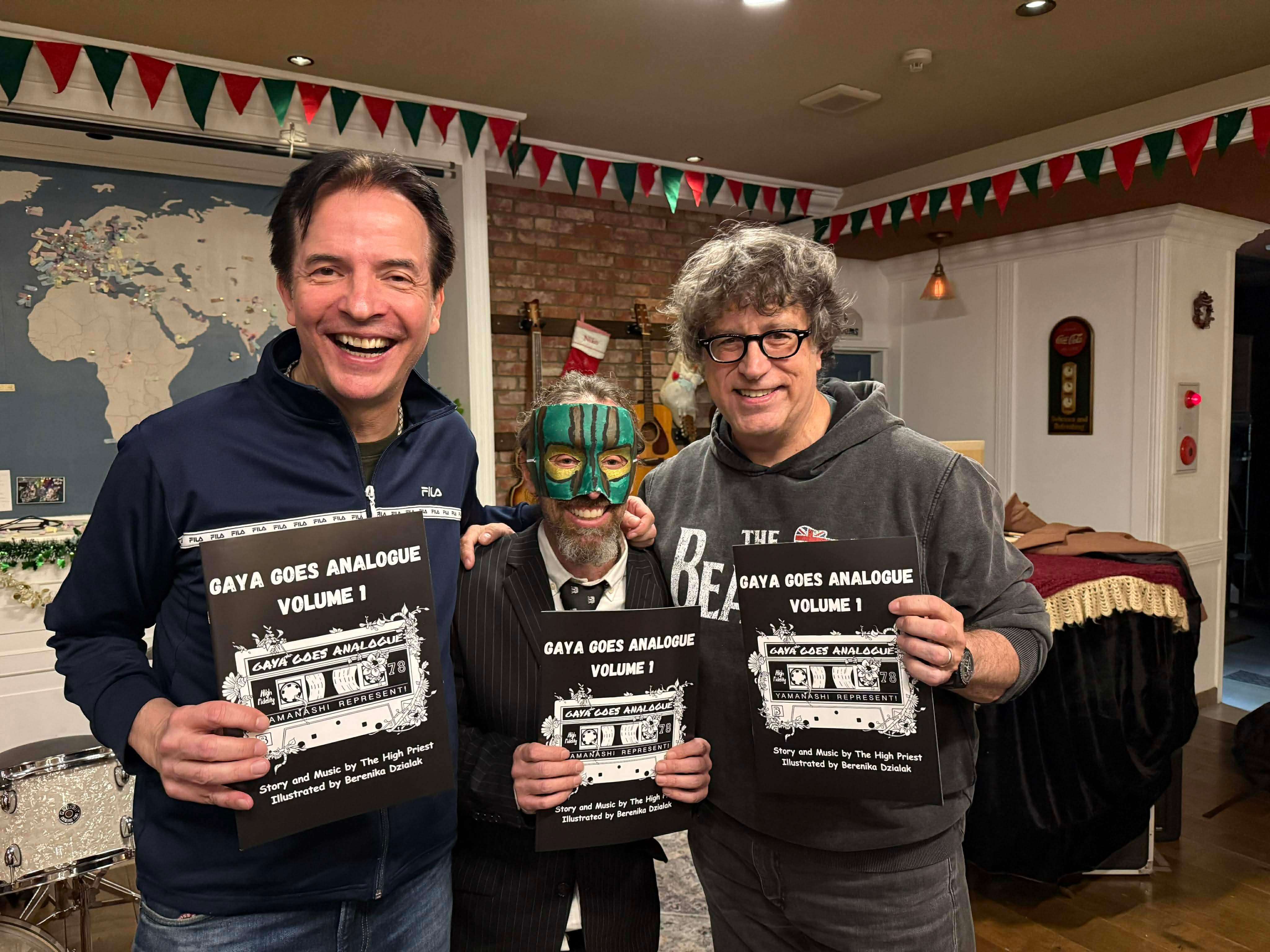 three men are holding up signs in a room