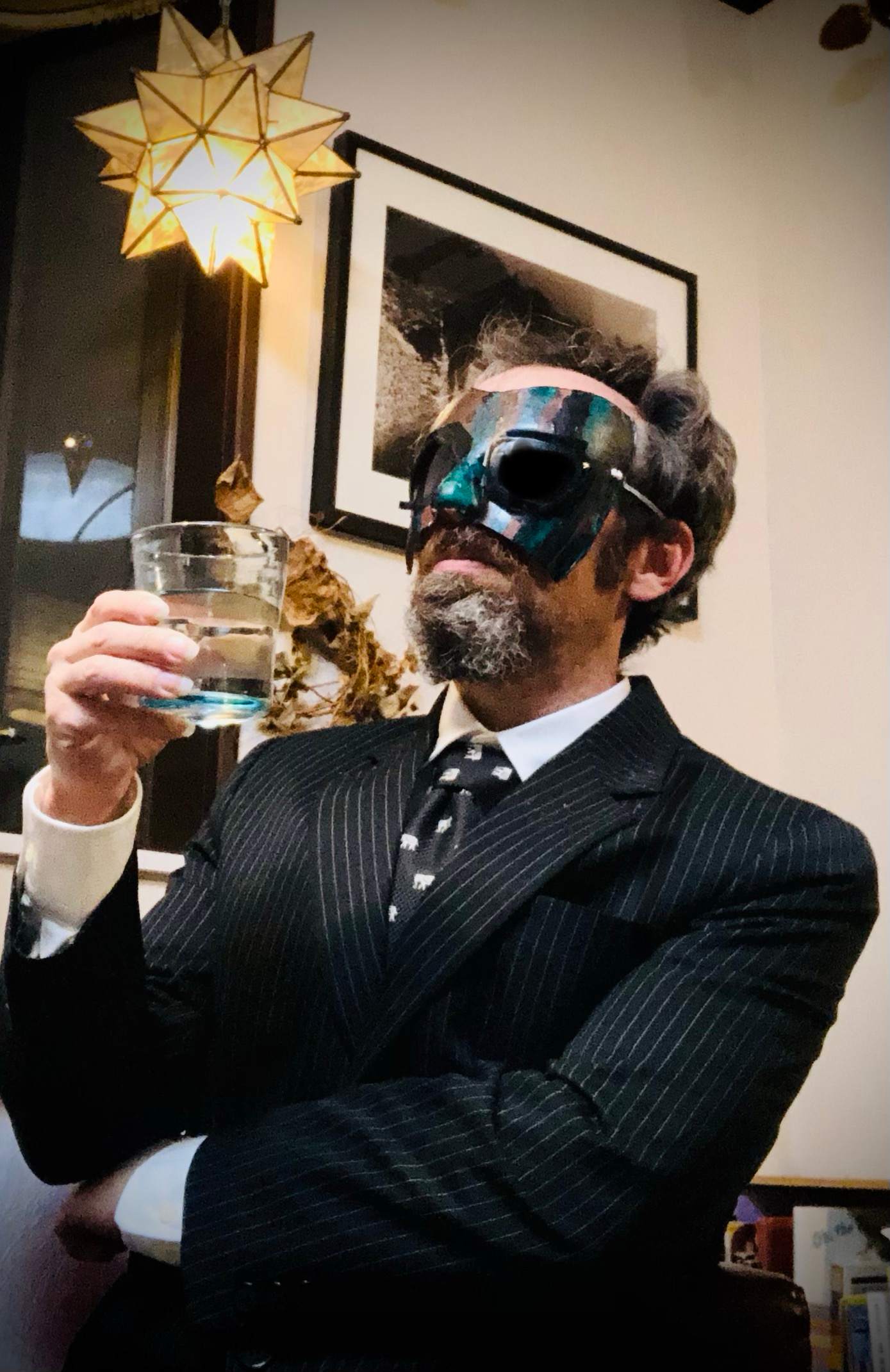 a man in a suit holding a glass of water