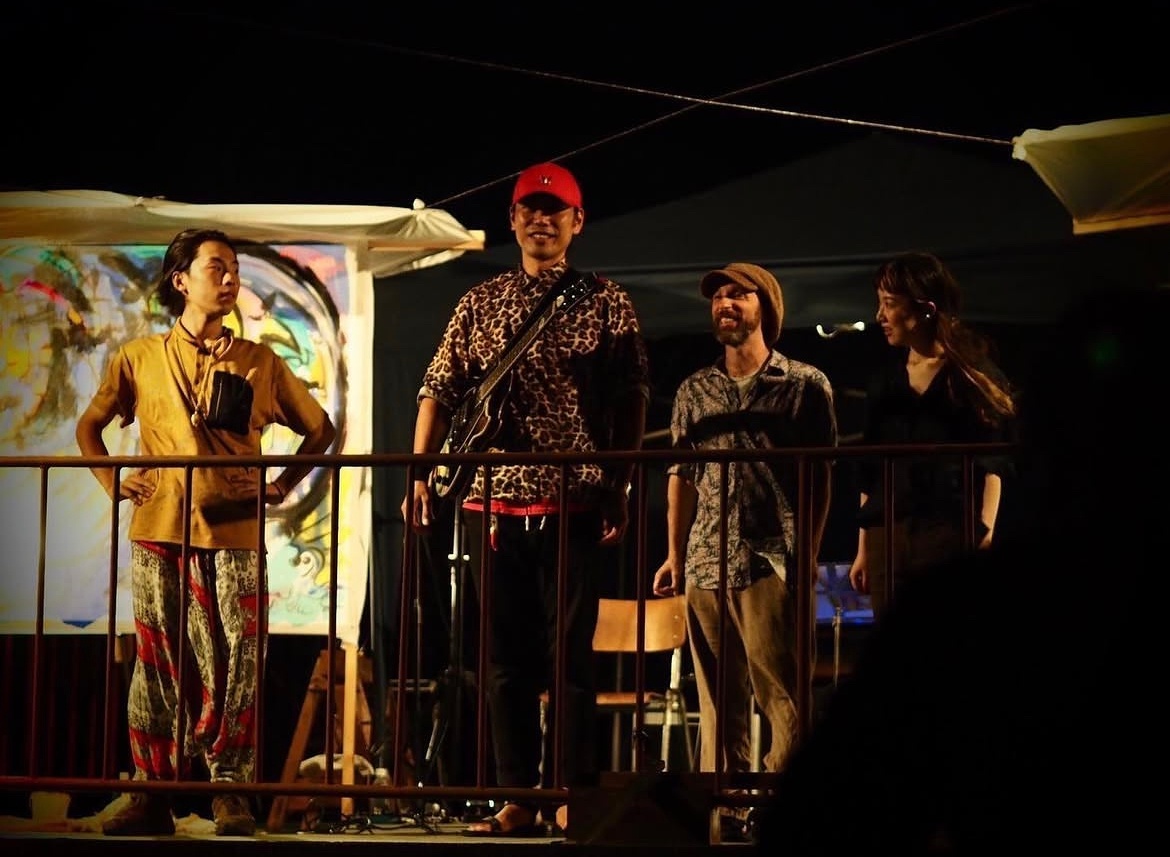 a group of people standing on a balcony at night