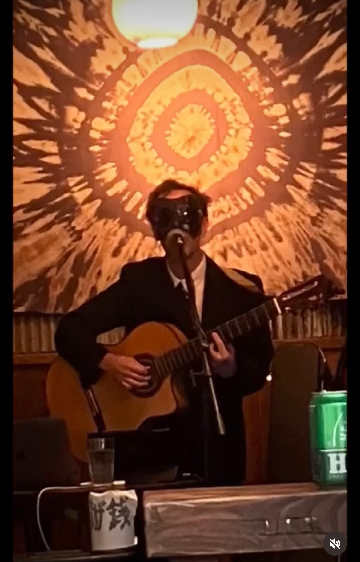 a man in a suit playing an acoustic guitar
