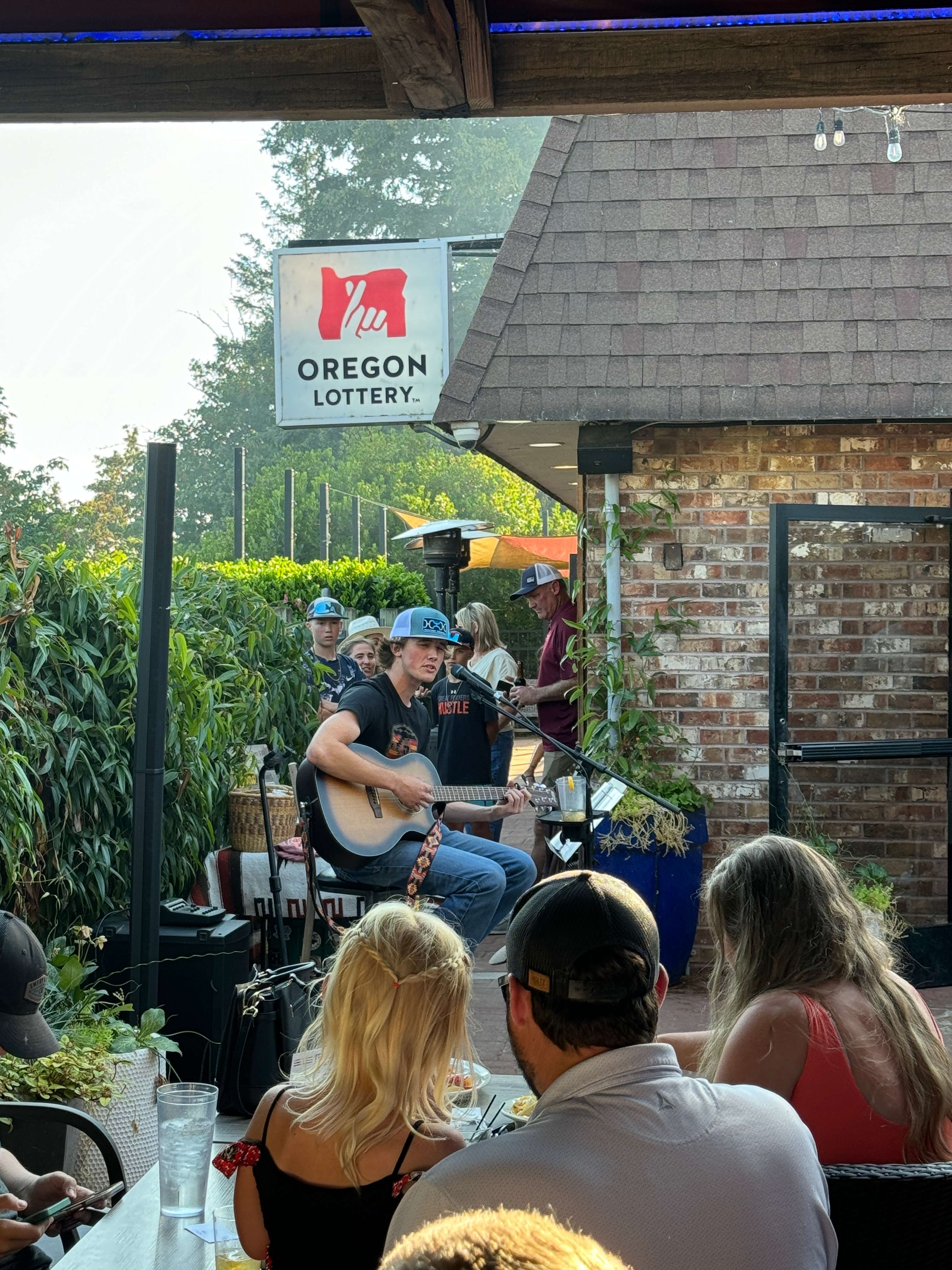 a group of people sitting at a table and listening to music