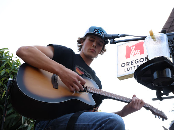a man playing an acoustic guitar