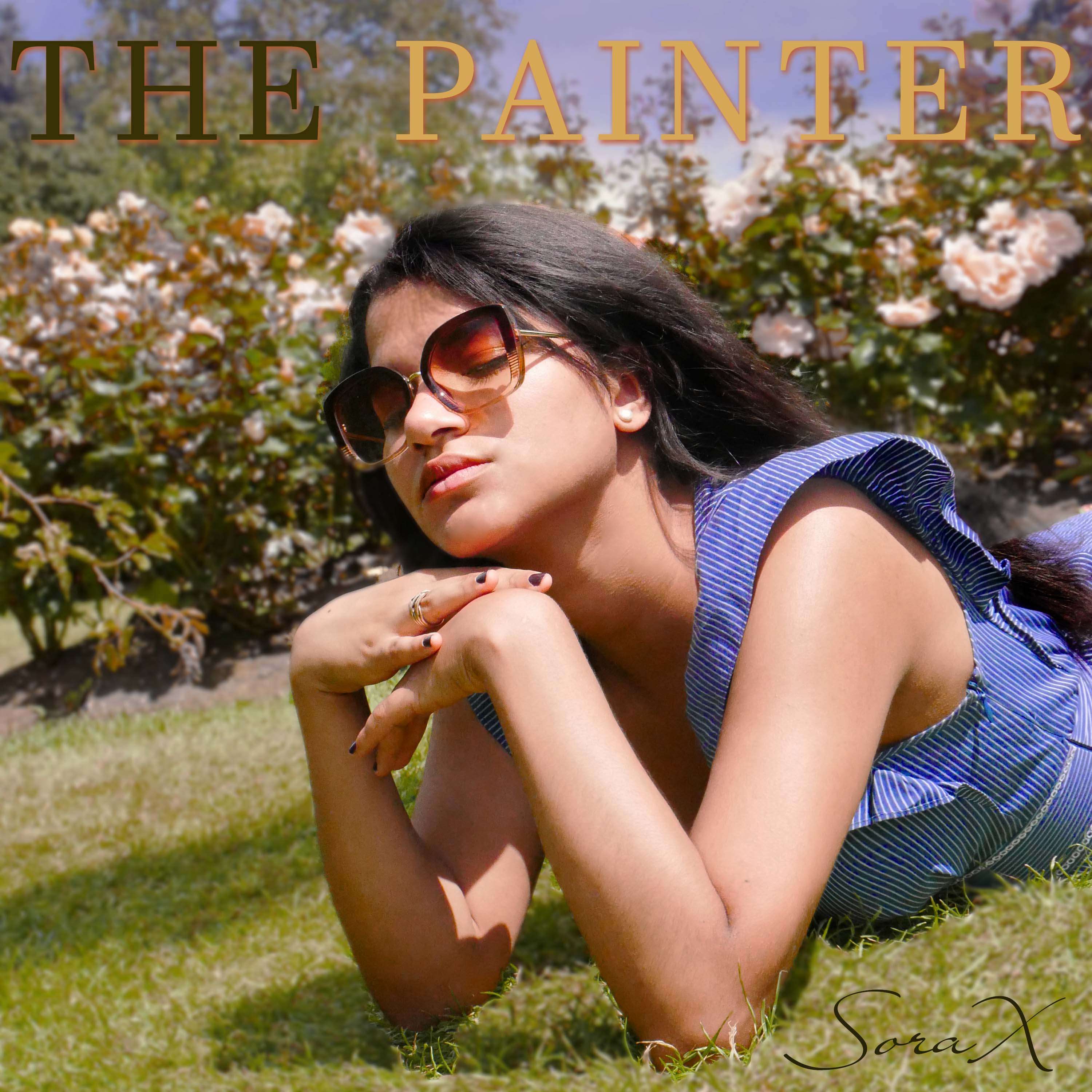 a woman laying on the grass with sunglasses