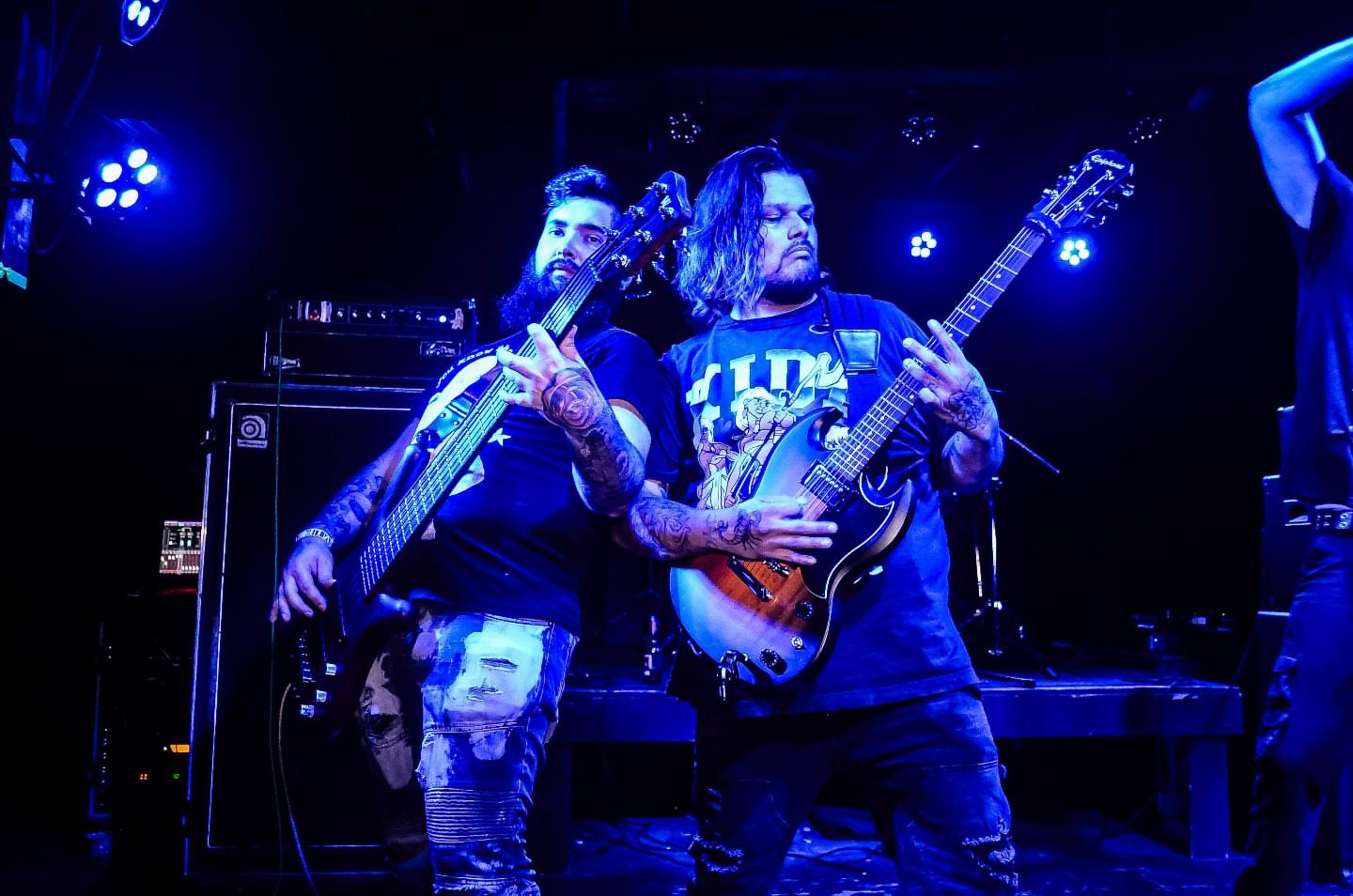 a group of men playing guitars on stage