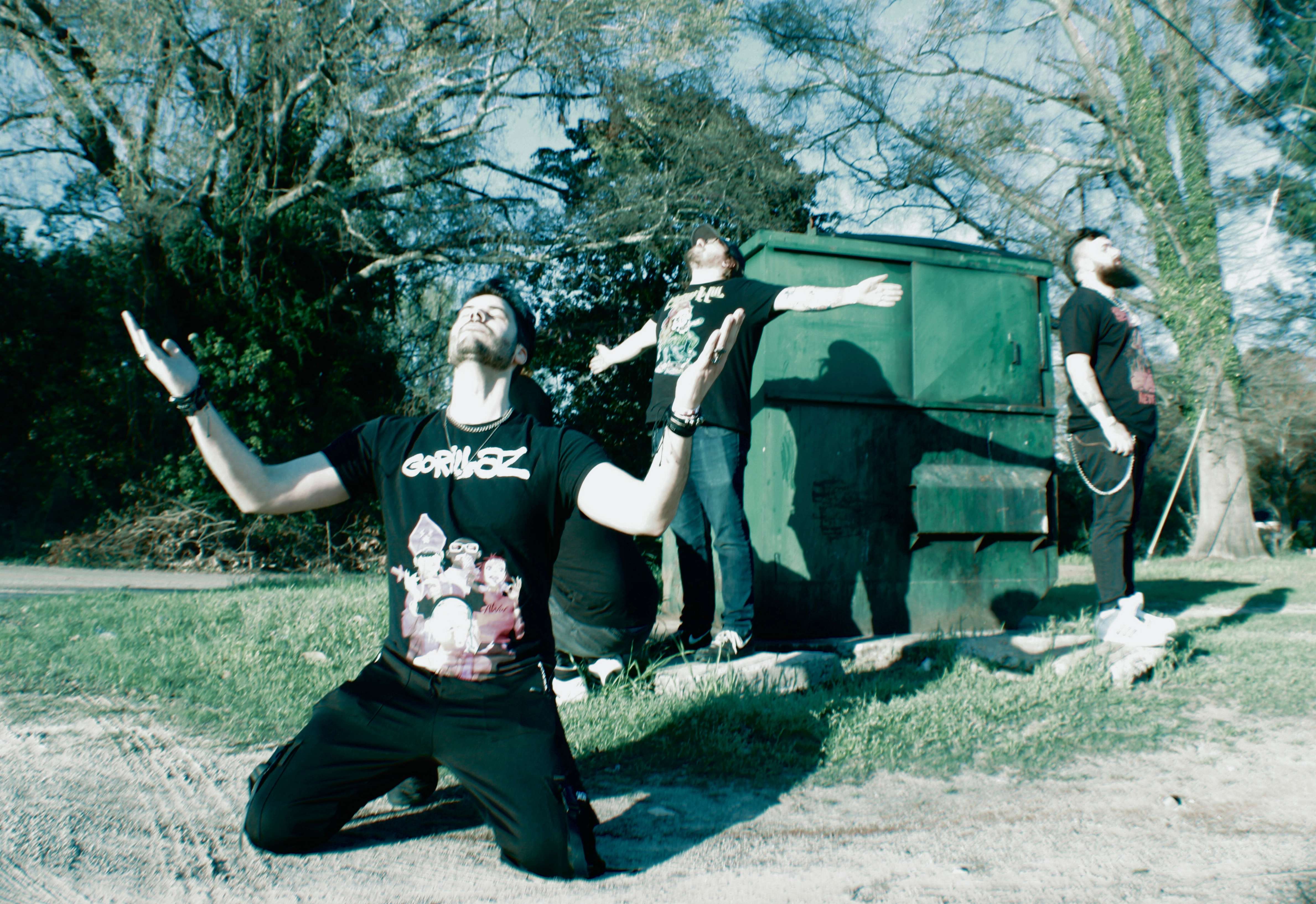 a group of people posing in front of a trash can