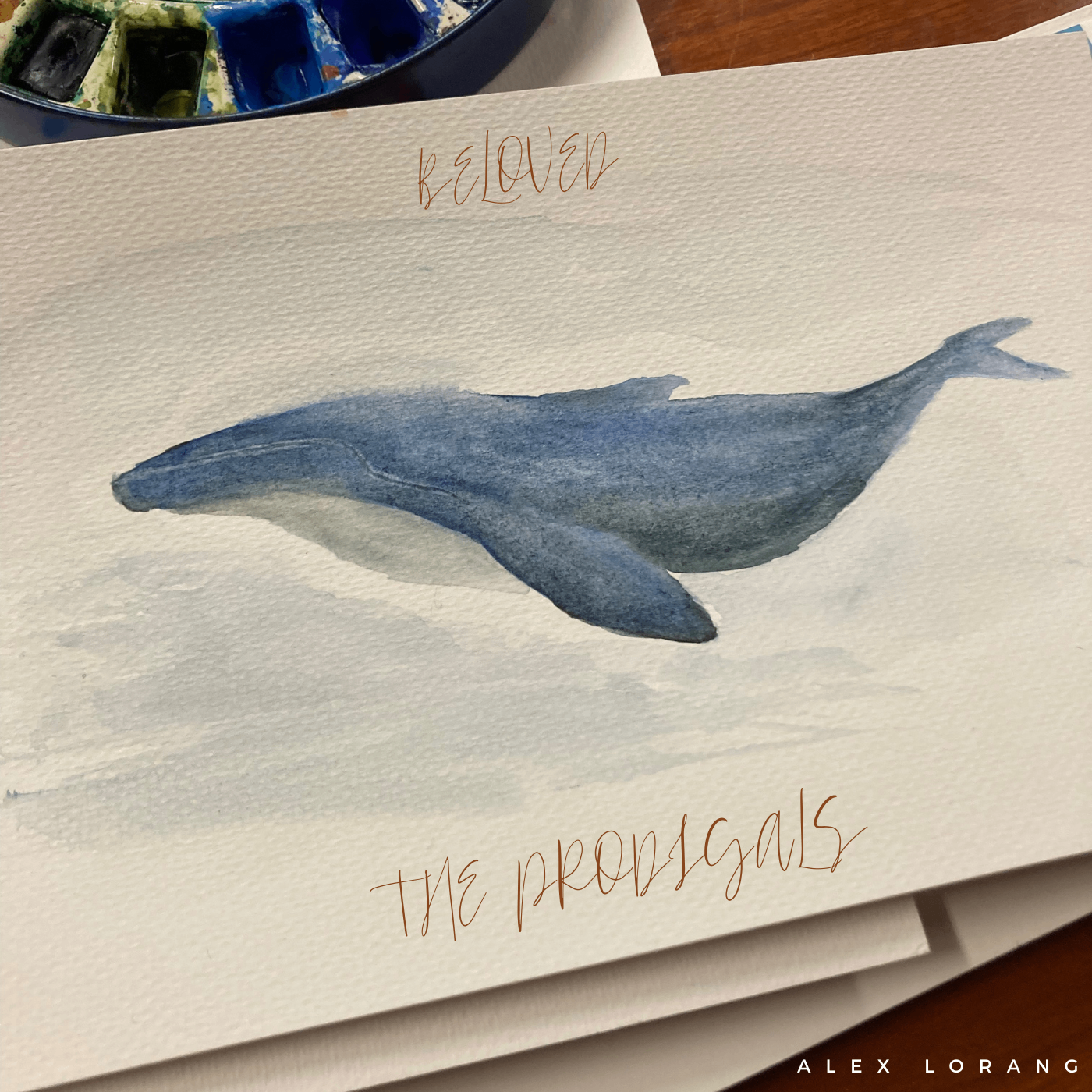 Alex Lorang - Beloved I: The Prodigals: a watercolor painting of a whale with the words believe