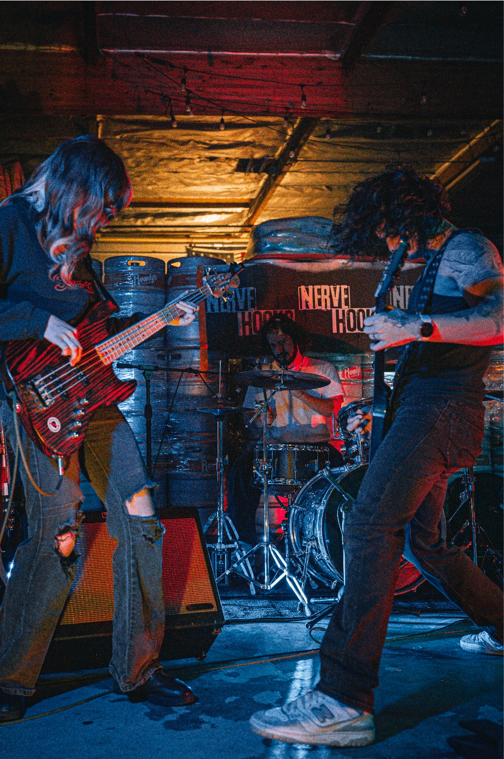 a group of people playing guitars on stage