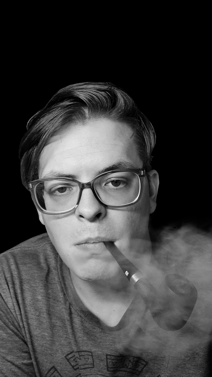 a man with glasses smoking a pipe