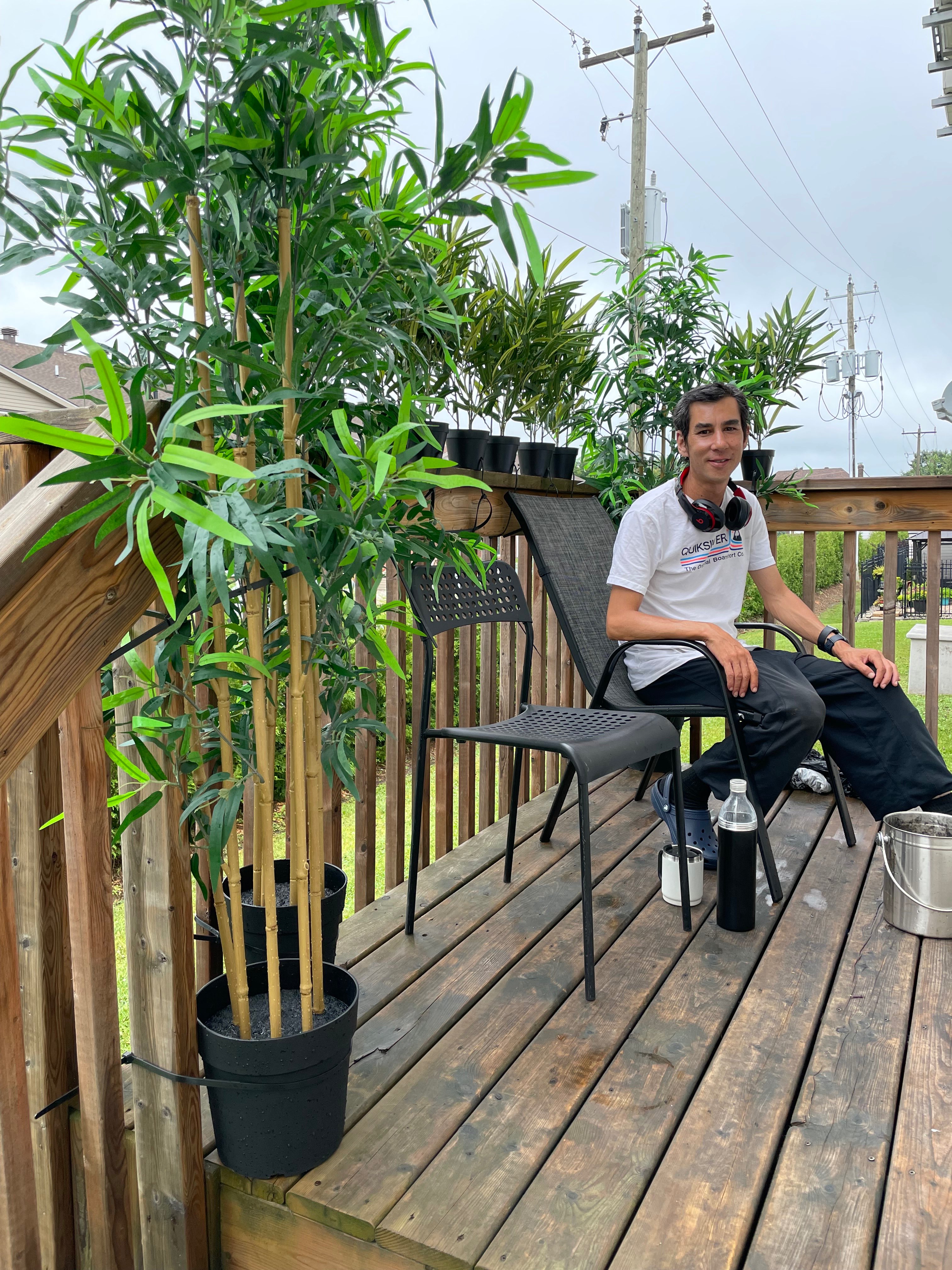 a man sitting on a wooden deck