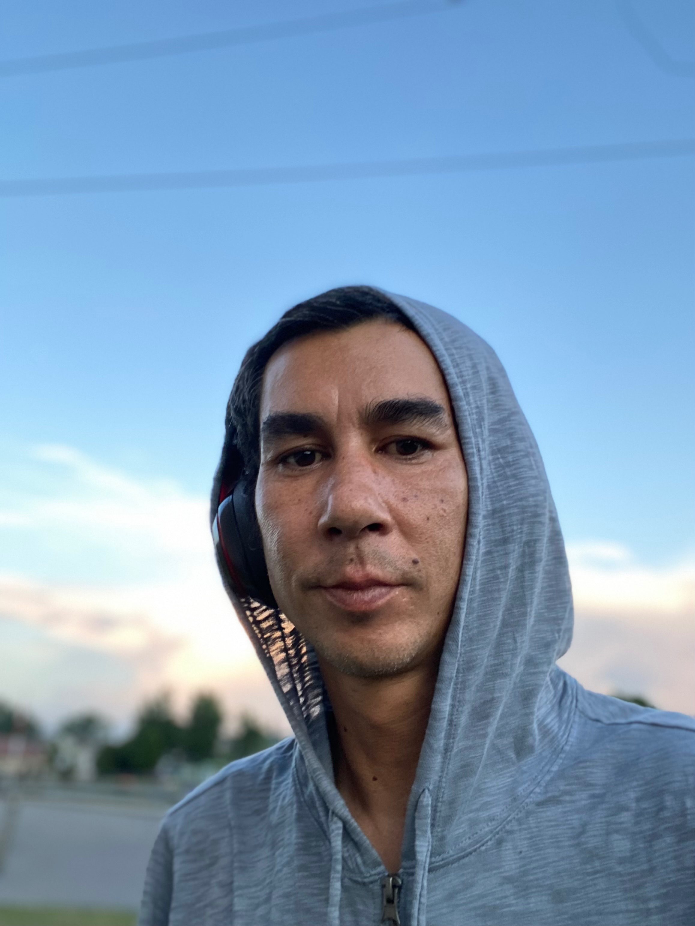 a man wearing a hoodie and headphones