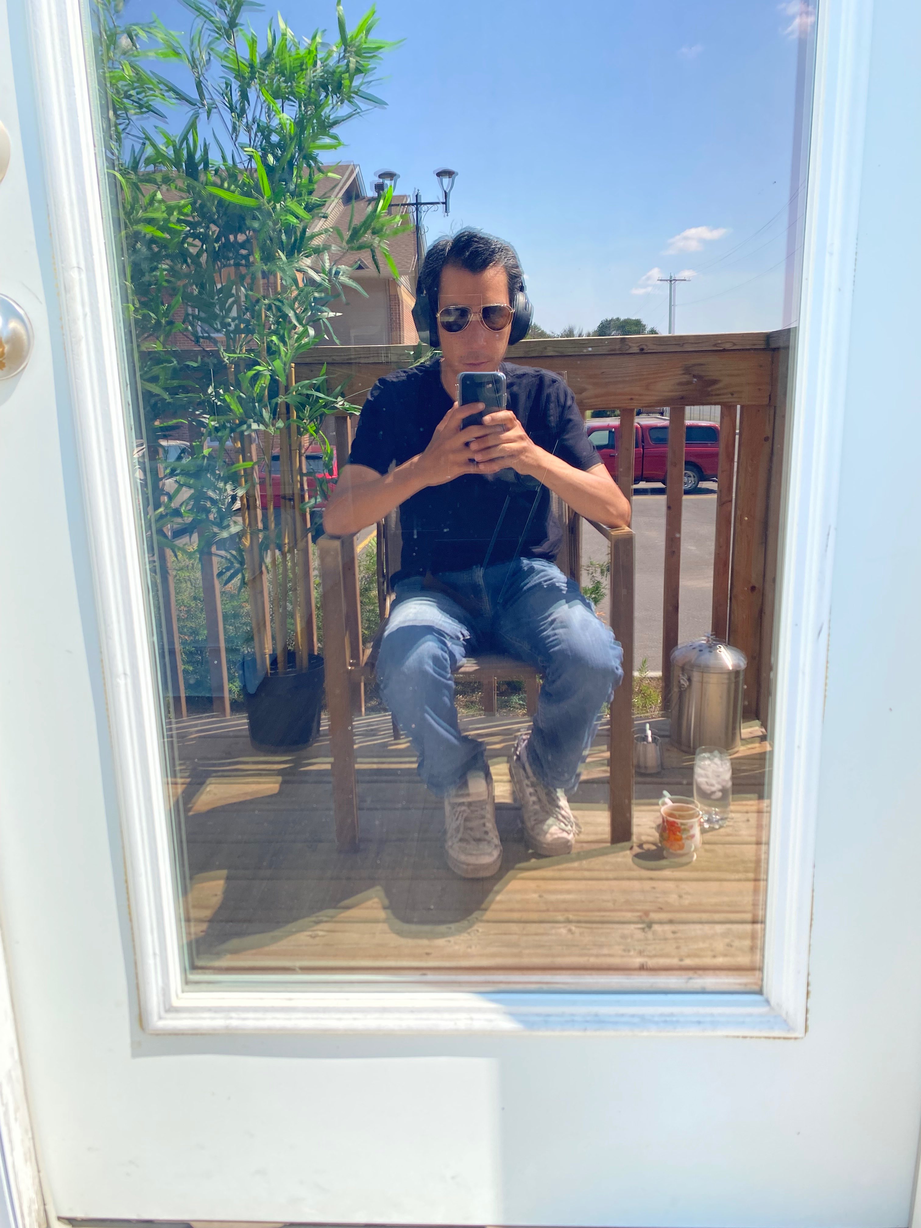 a man sitting on a chair in front of a door