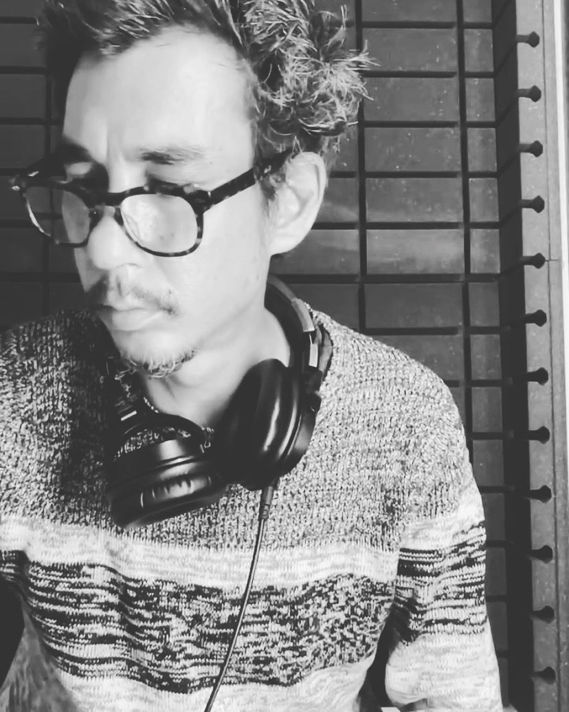 a black and white photo of a man wearing headphones