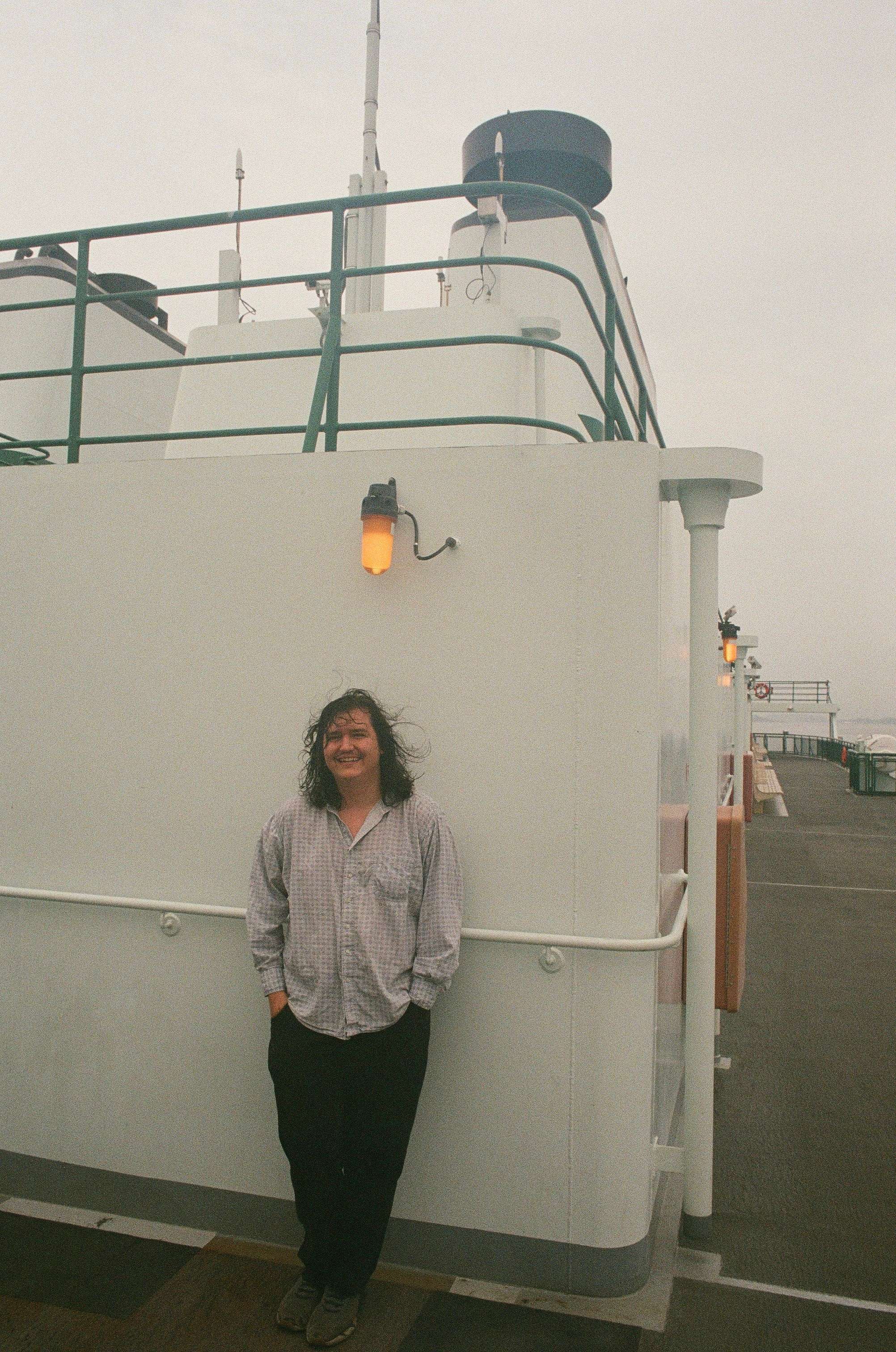 a man standing on the side of a boat