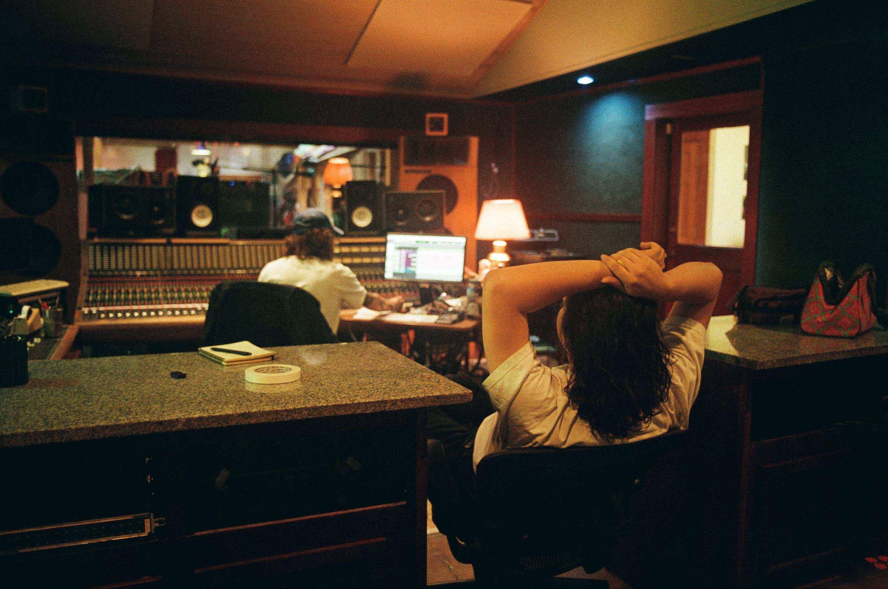 a woman sitting in a recording studio