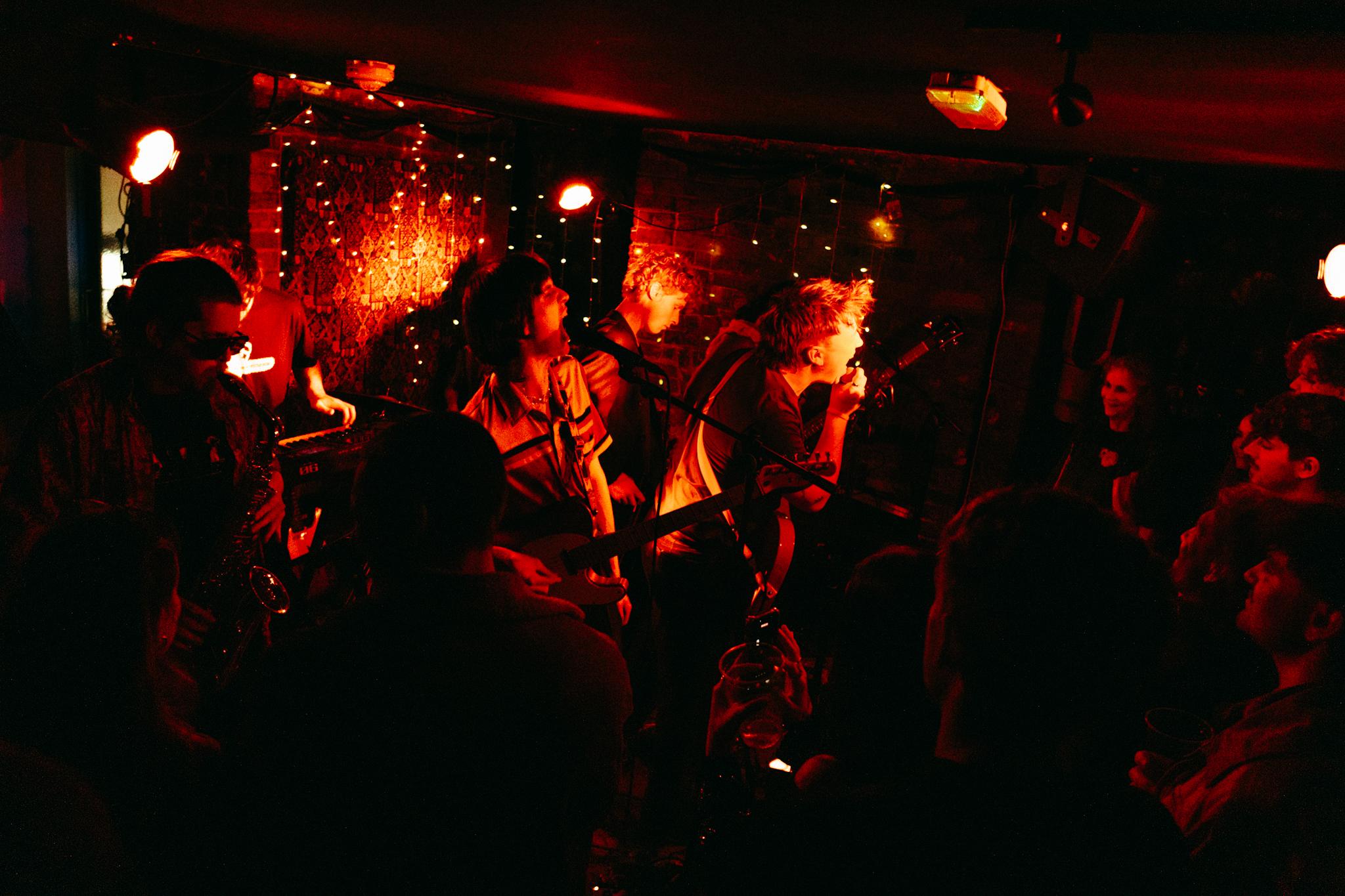a group of people standing in a dark room
