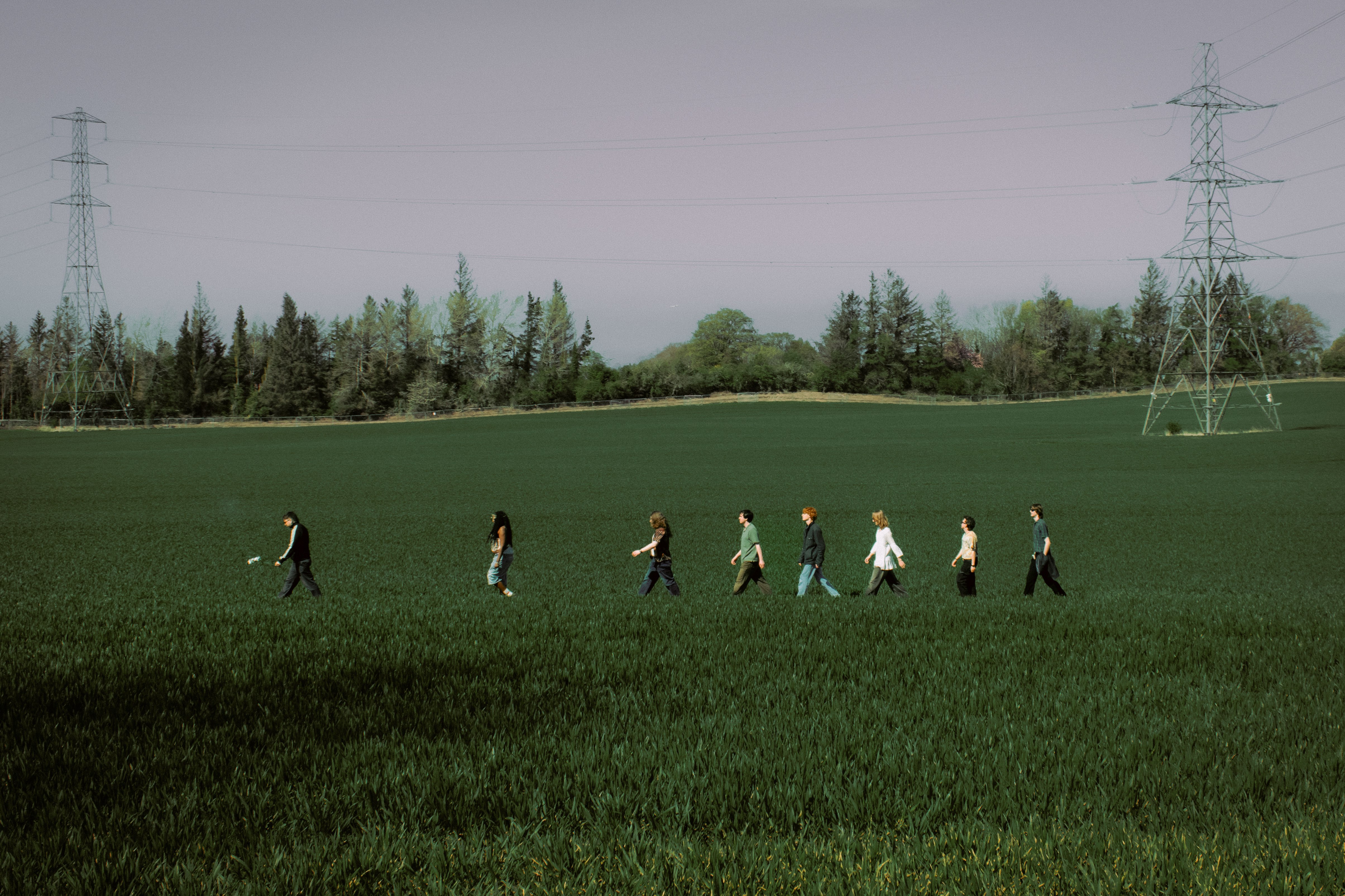a group of people walking through a field