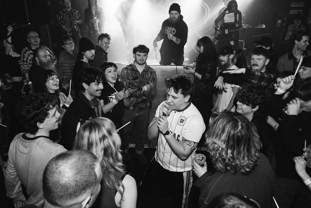 a group of people standing in a crowd at a concert