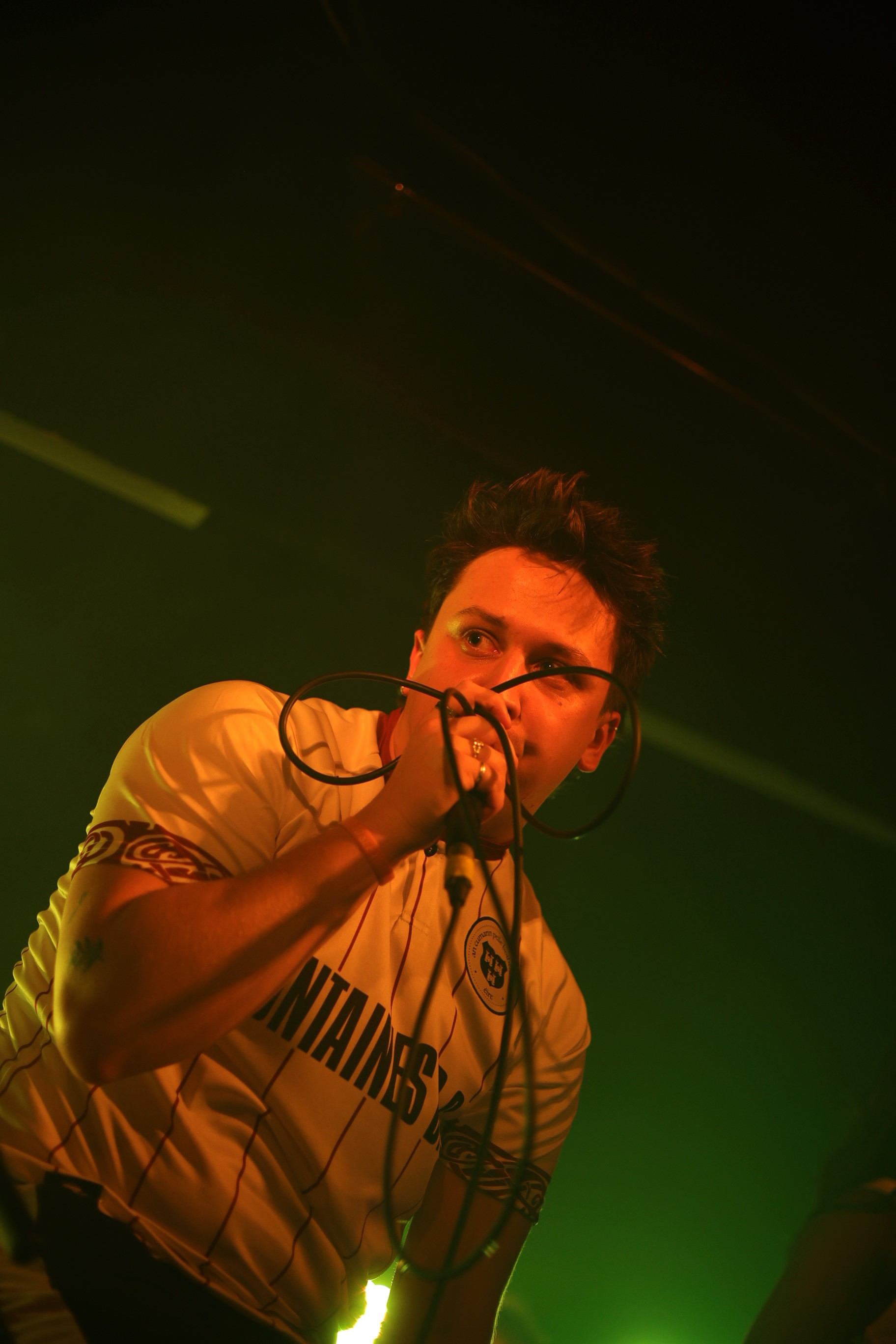 a man singing into a microphone on stage