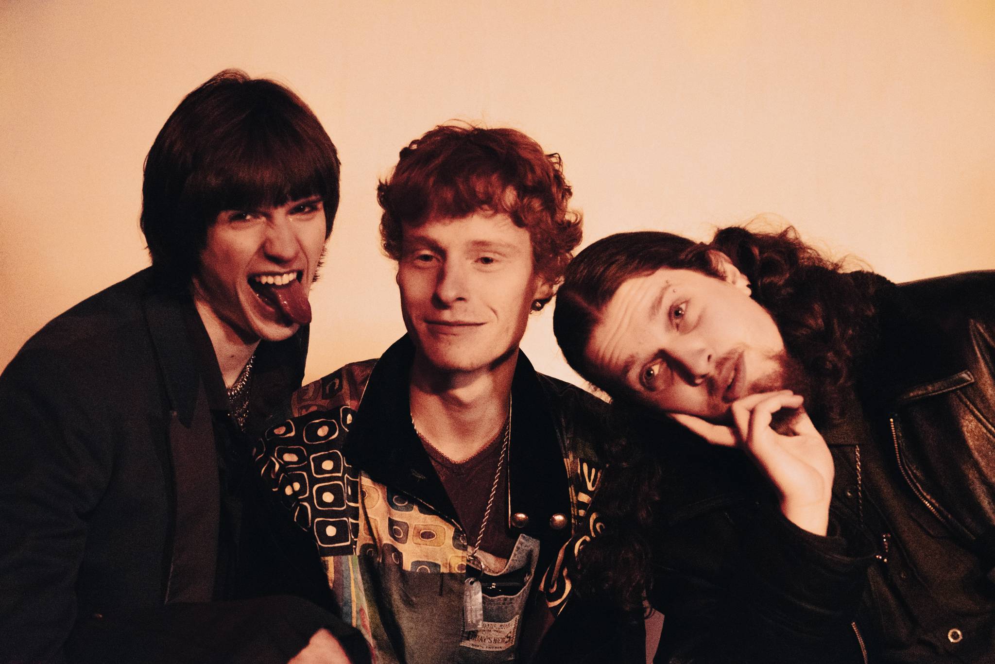 three young men are posing for a picture