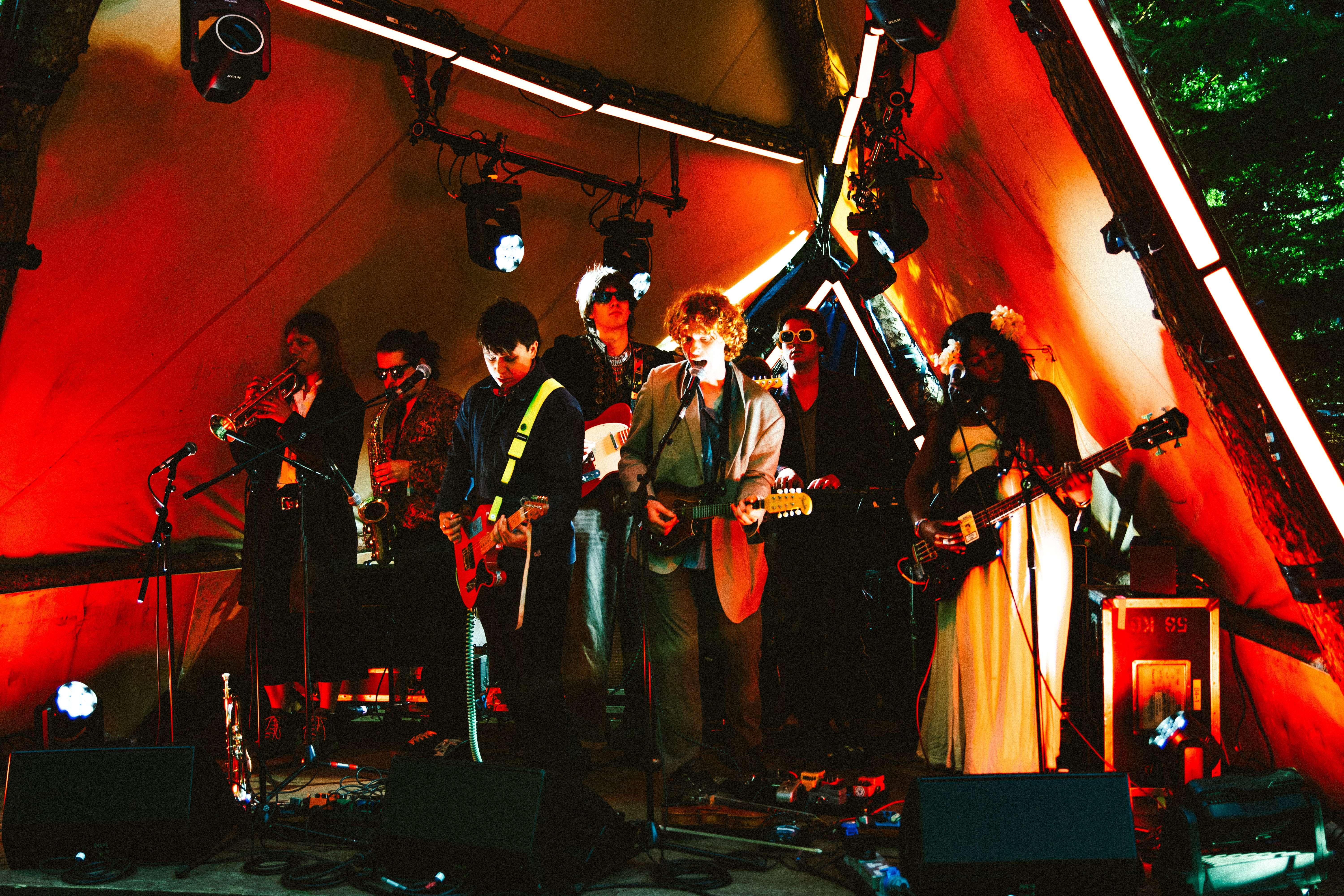 a group of people standing in front of a tent