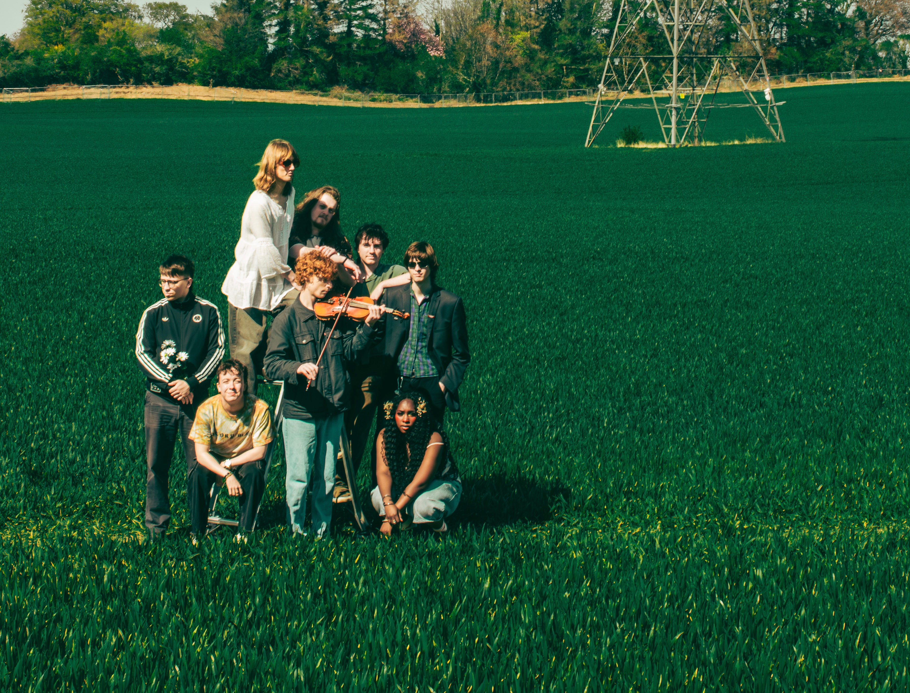 a group of people posing for a picture in a field