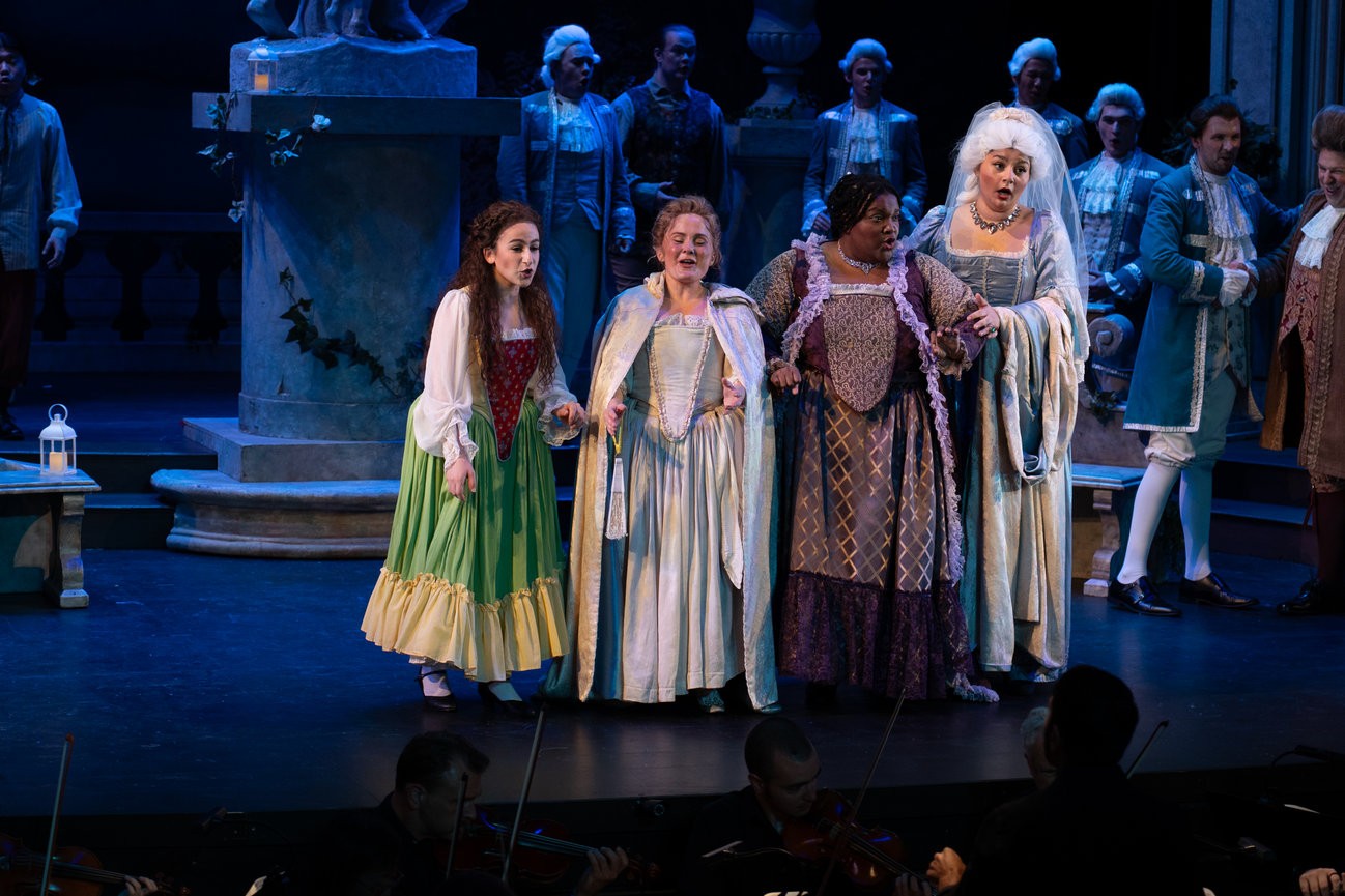 a group of people in costumes on stage