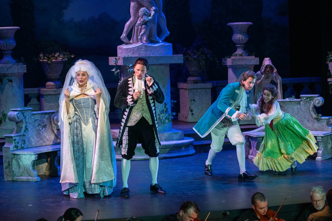 a group of people dressed in period costumes on stage