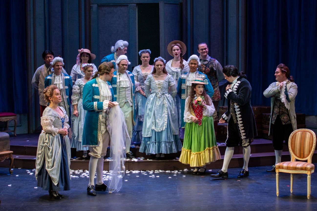 a group of people in costumes on stage