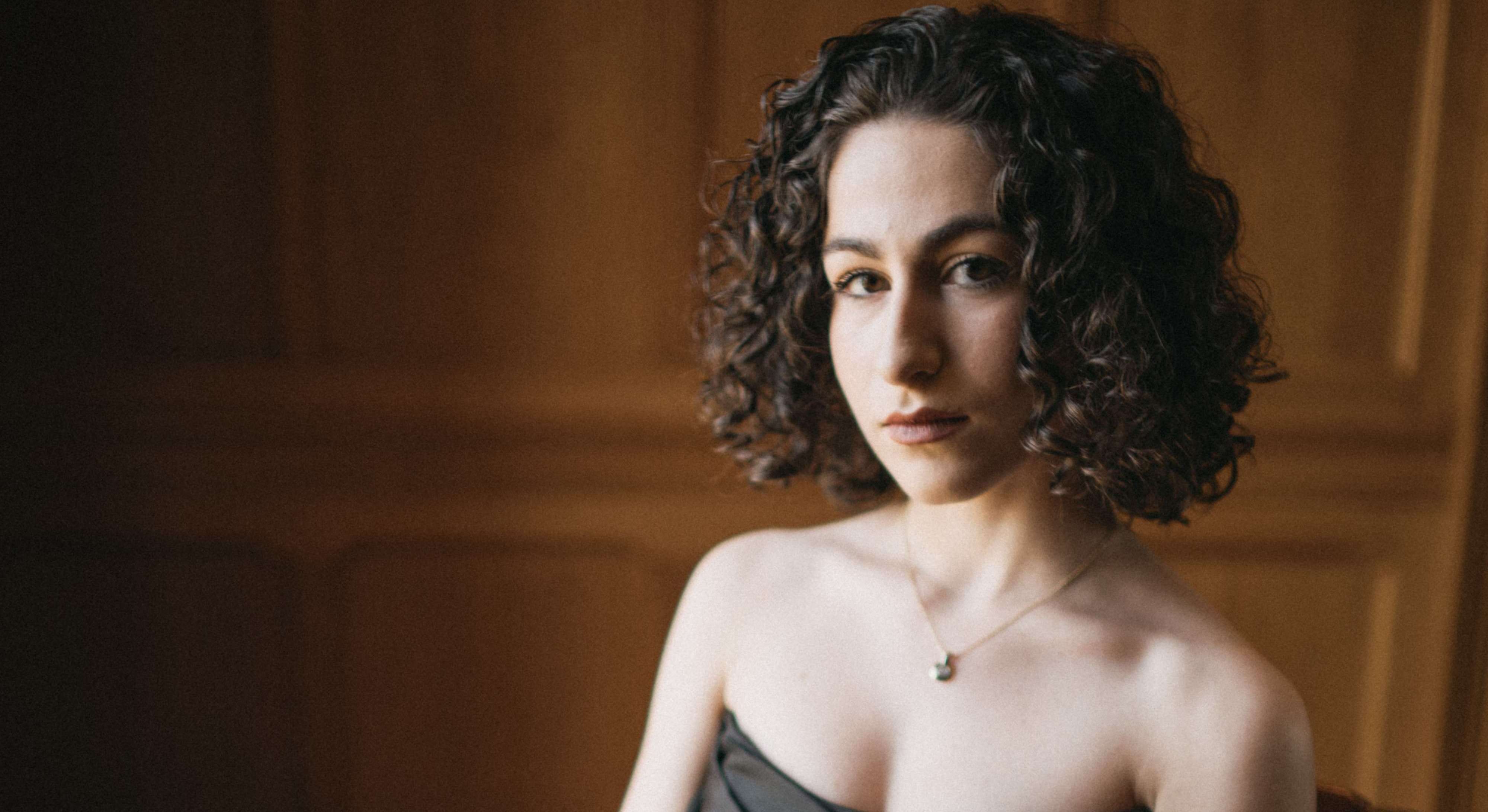 a woman in a black dress posing for a photo