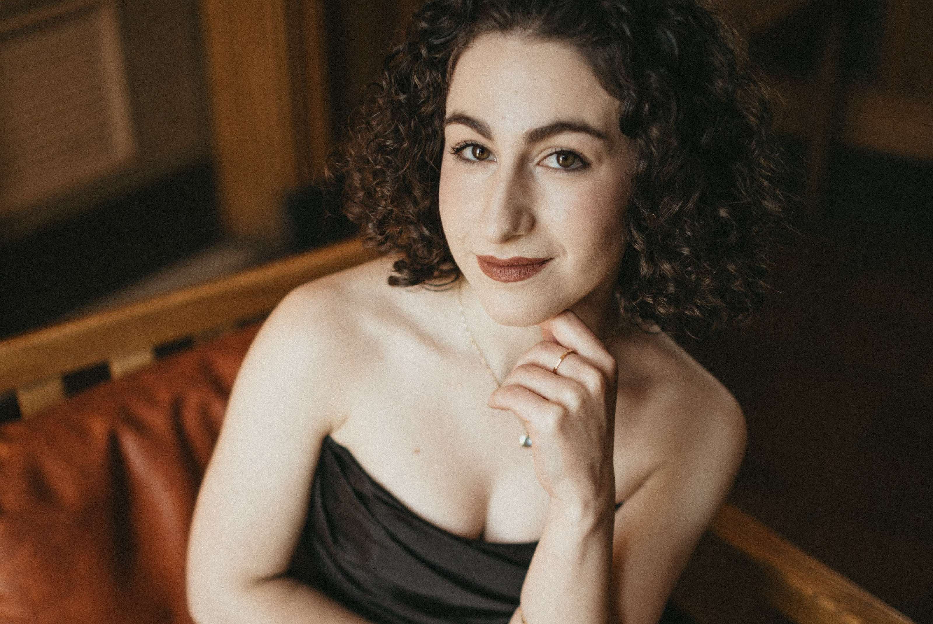 a woman in a black dress posing for a photo