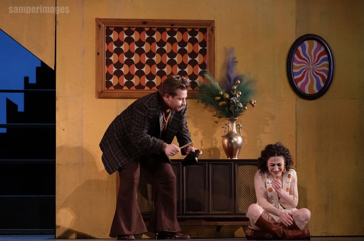 a man and a woman sitting on a stage