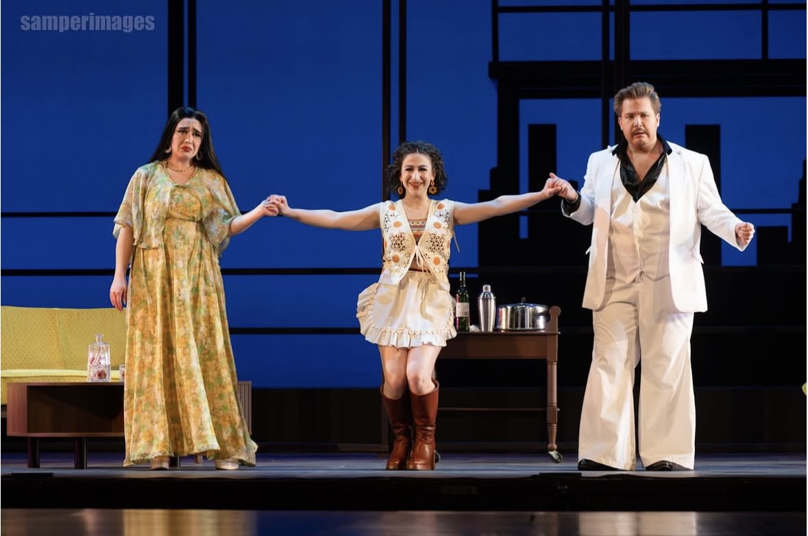 a group of people on stage with a woman and a man