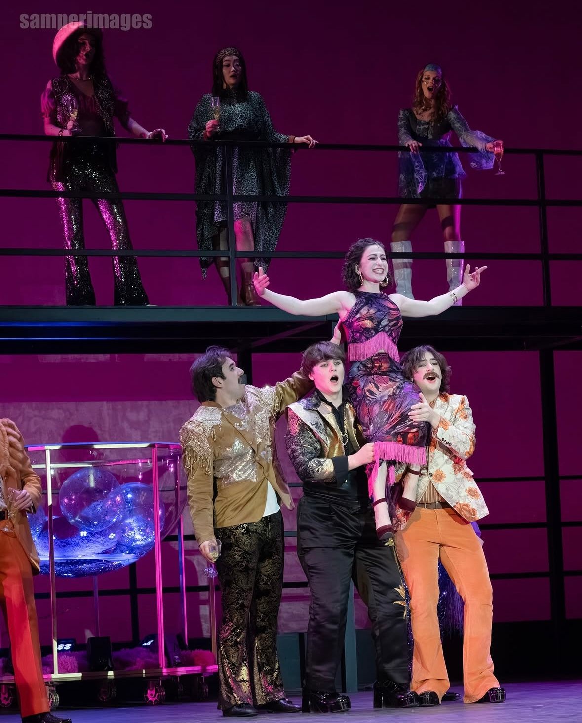 a group of people on stage performing a musical