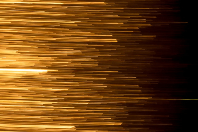 golden light streaks on a black background