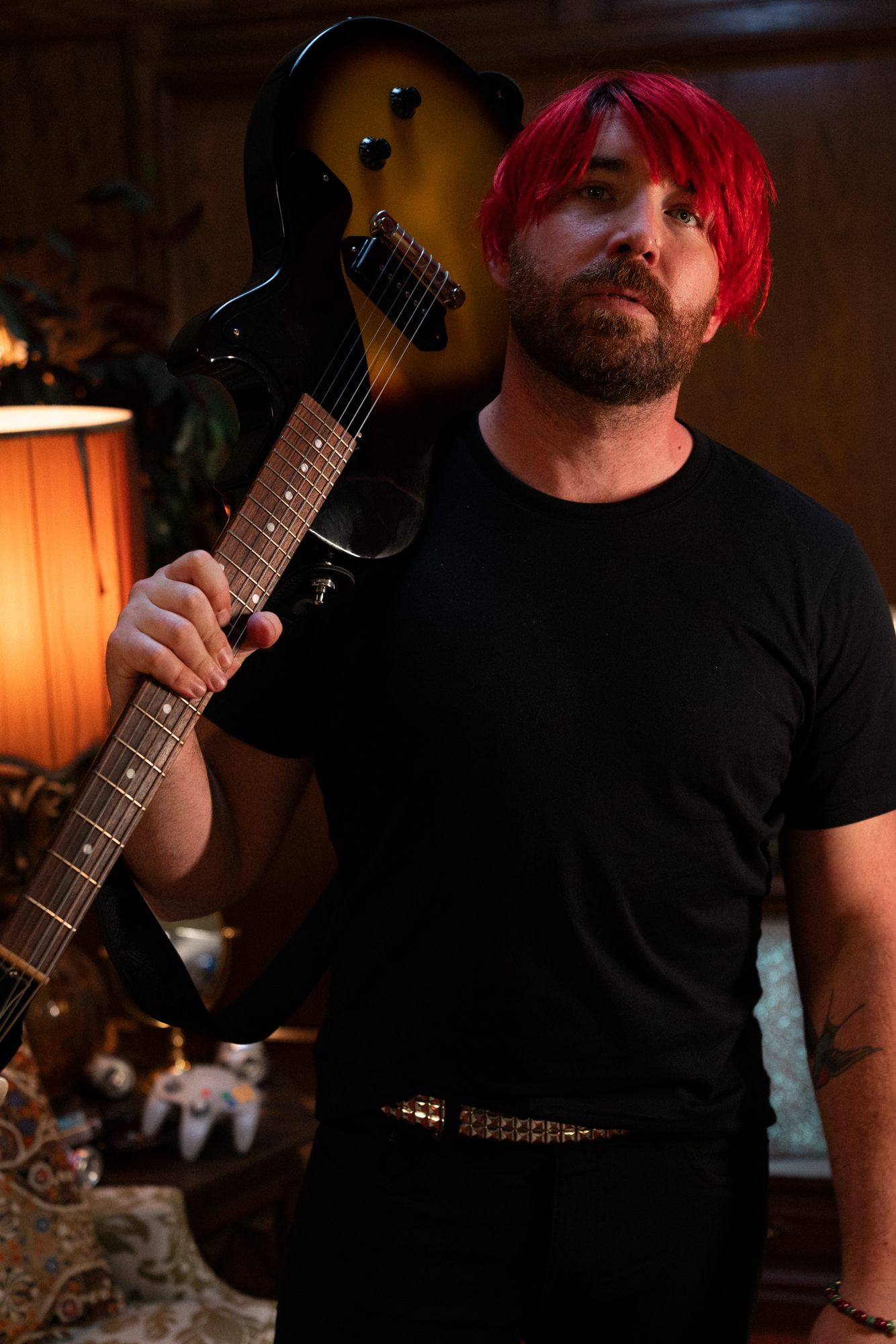 a man with red hair holding a guitar