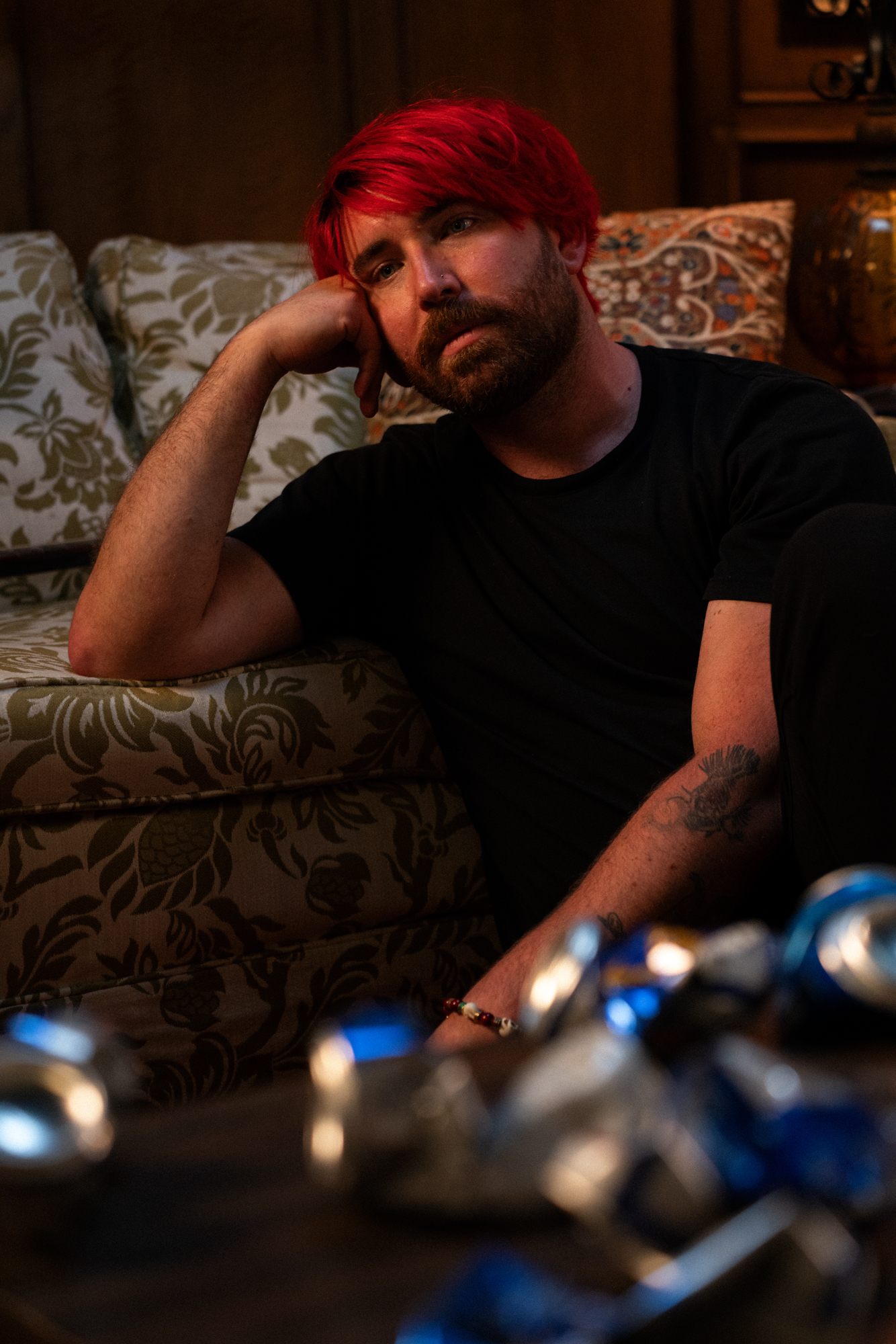 a man with red hair sitting on a couch