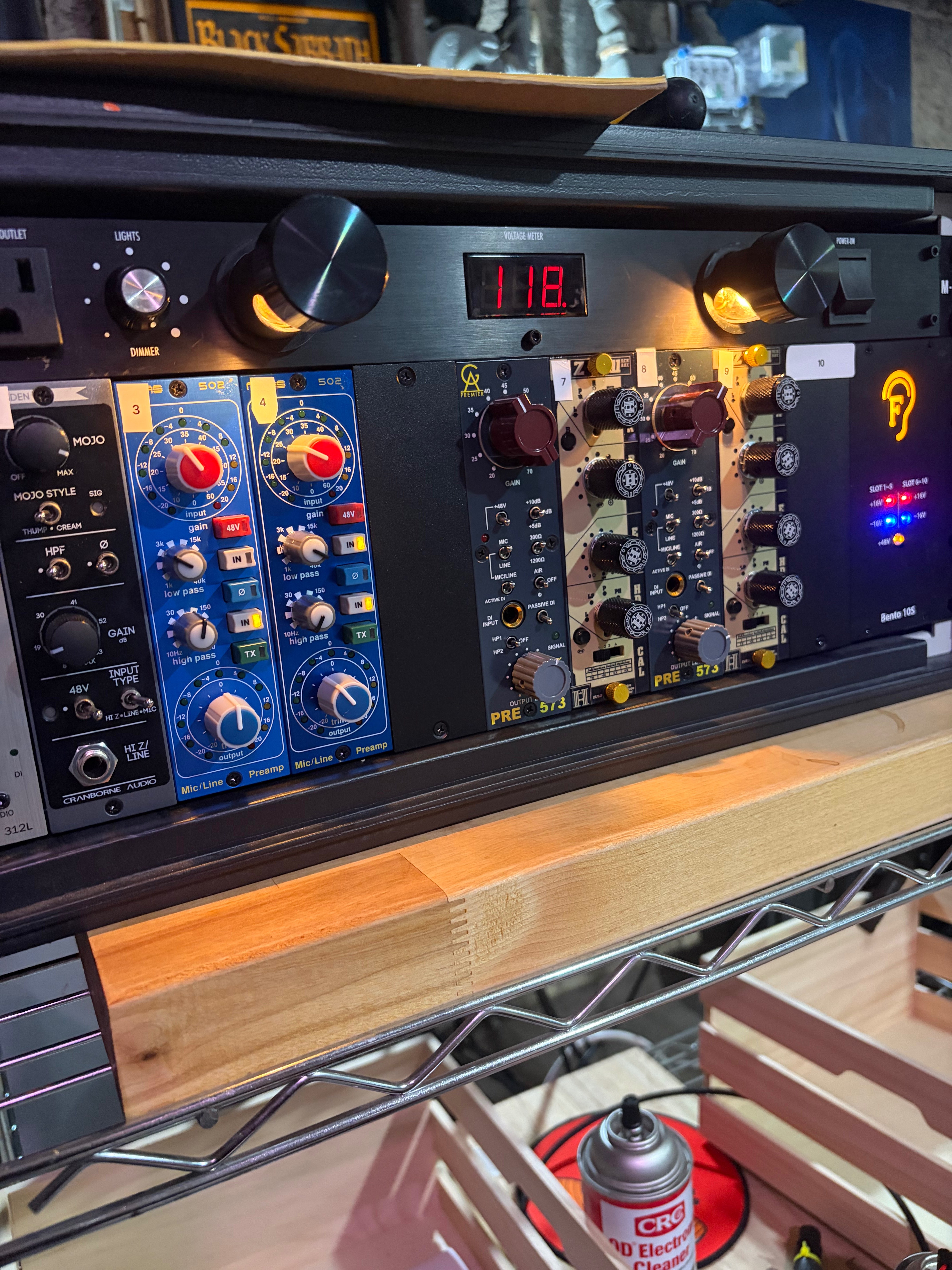 a rack of audio equipment sitting on top of a shelf