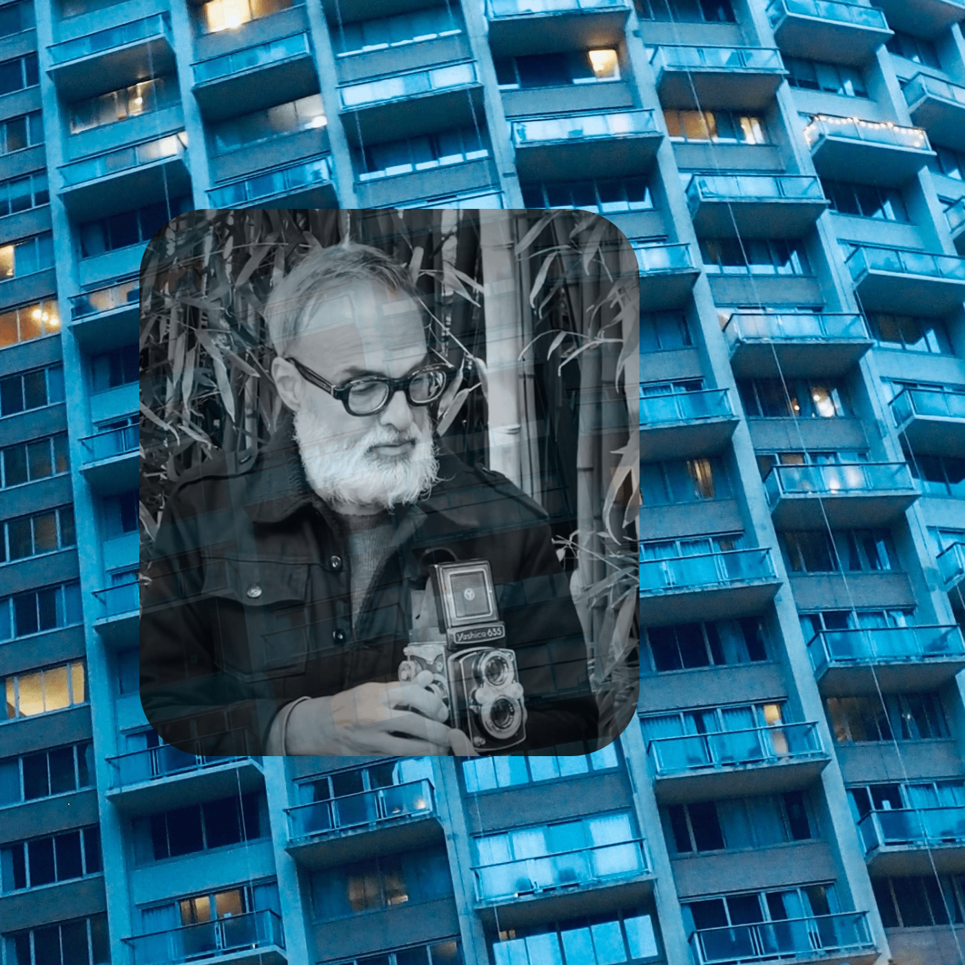 a man holding a camera in front of a building