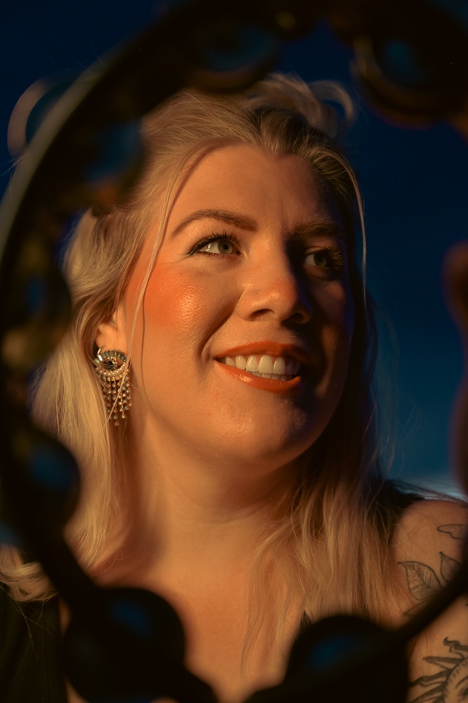 a woman with tattoos smiling in a mirror