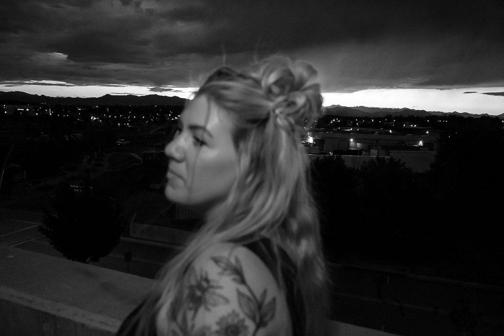 a black and white photo of a woman with tattoos