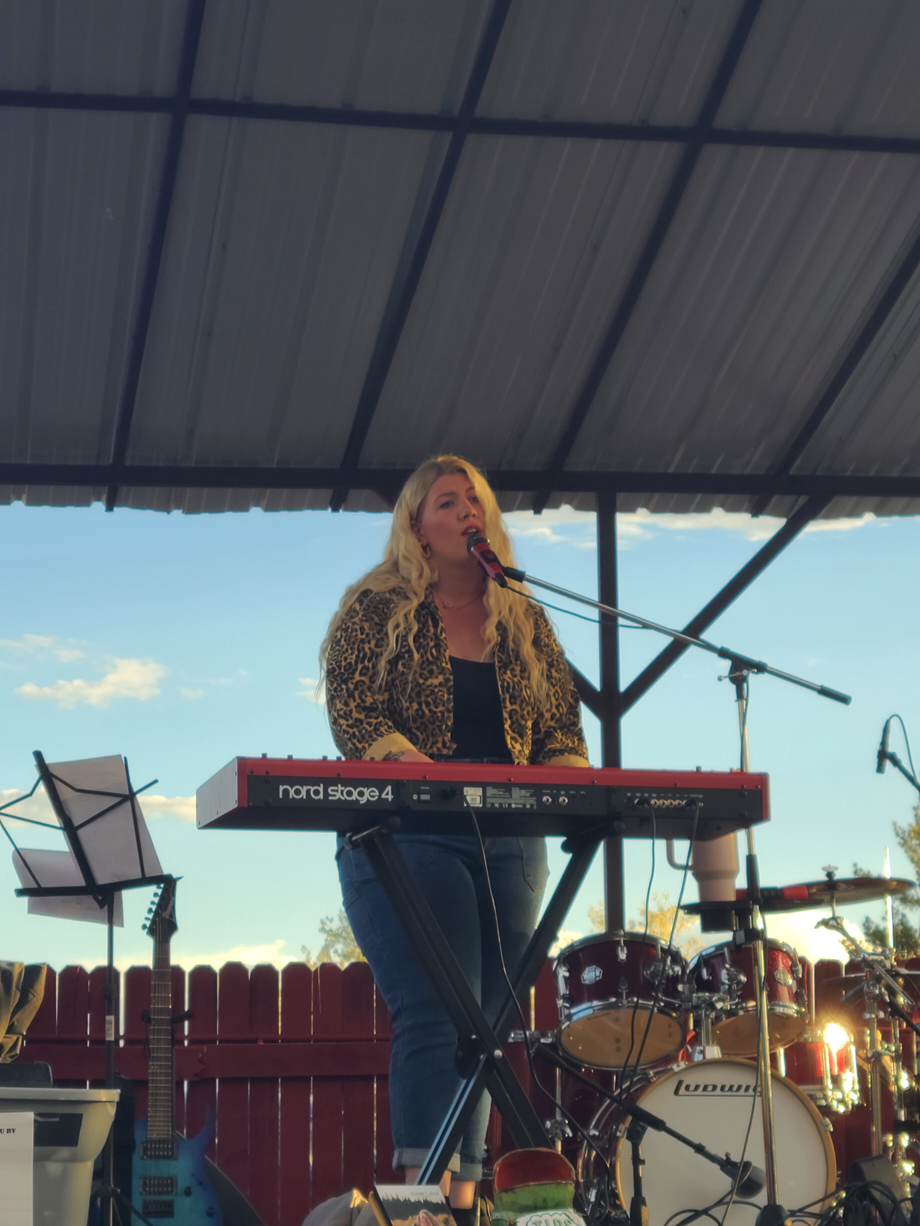a woman playing a keyboard on stage