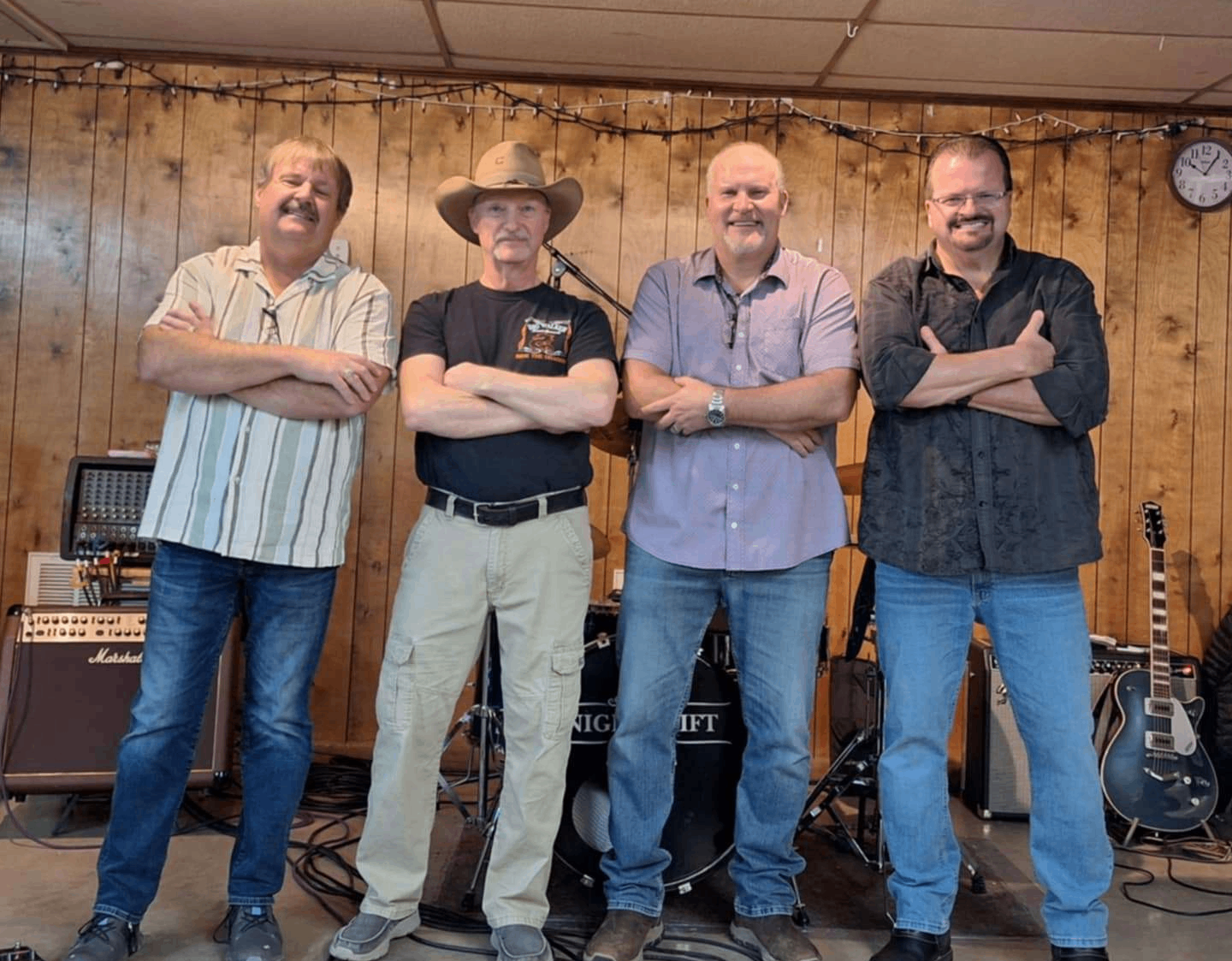 a group of men posing for a photo in a recording studio