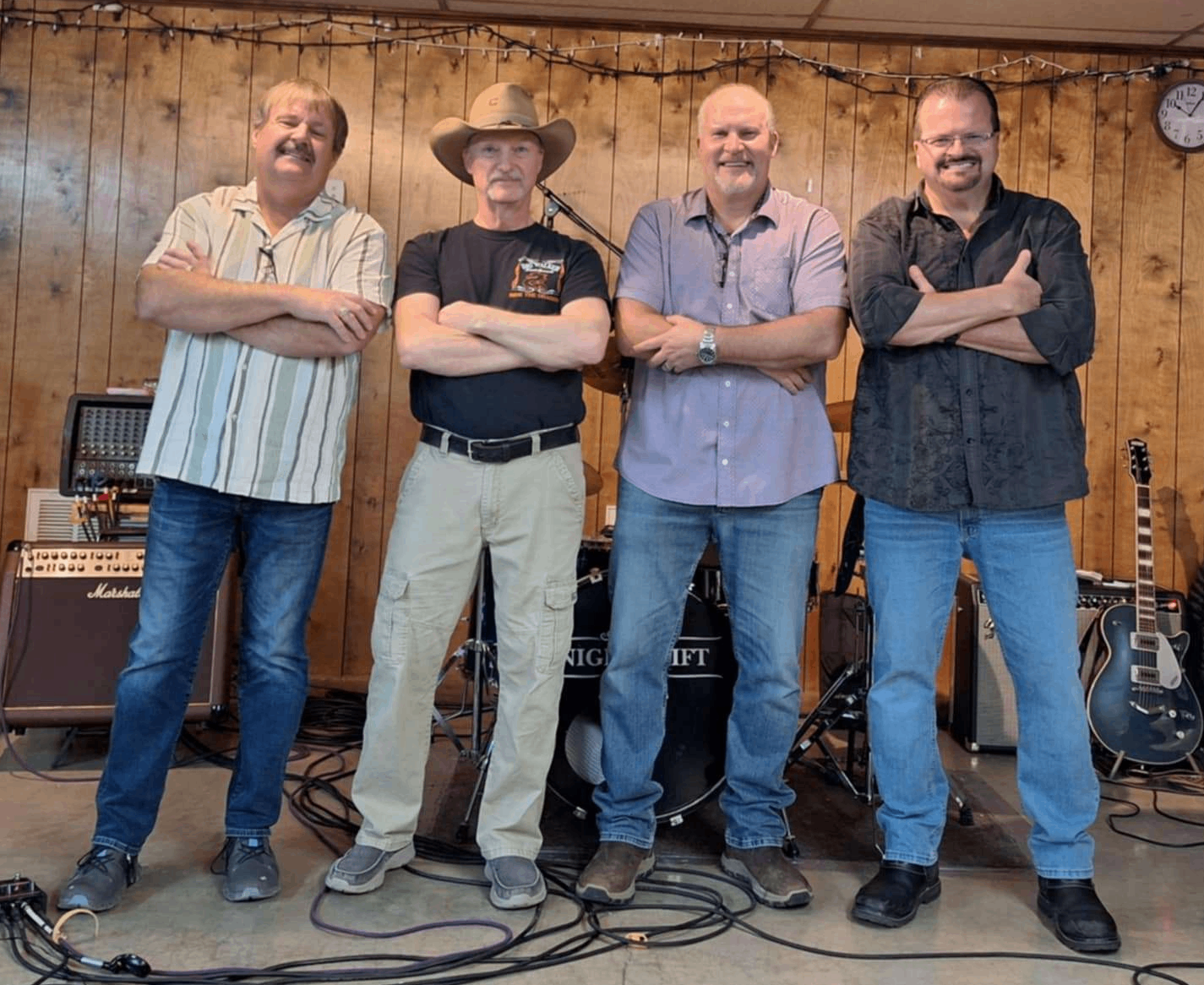 a group of men standing in front of a microphone