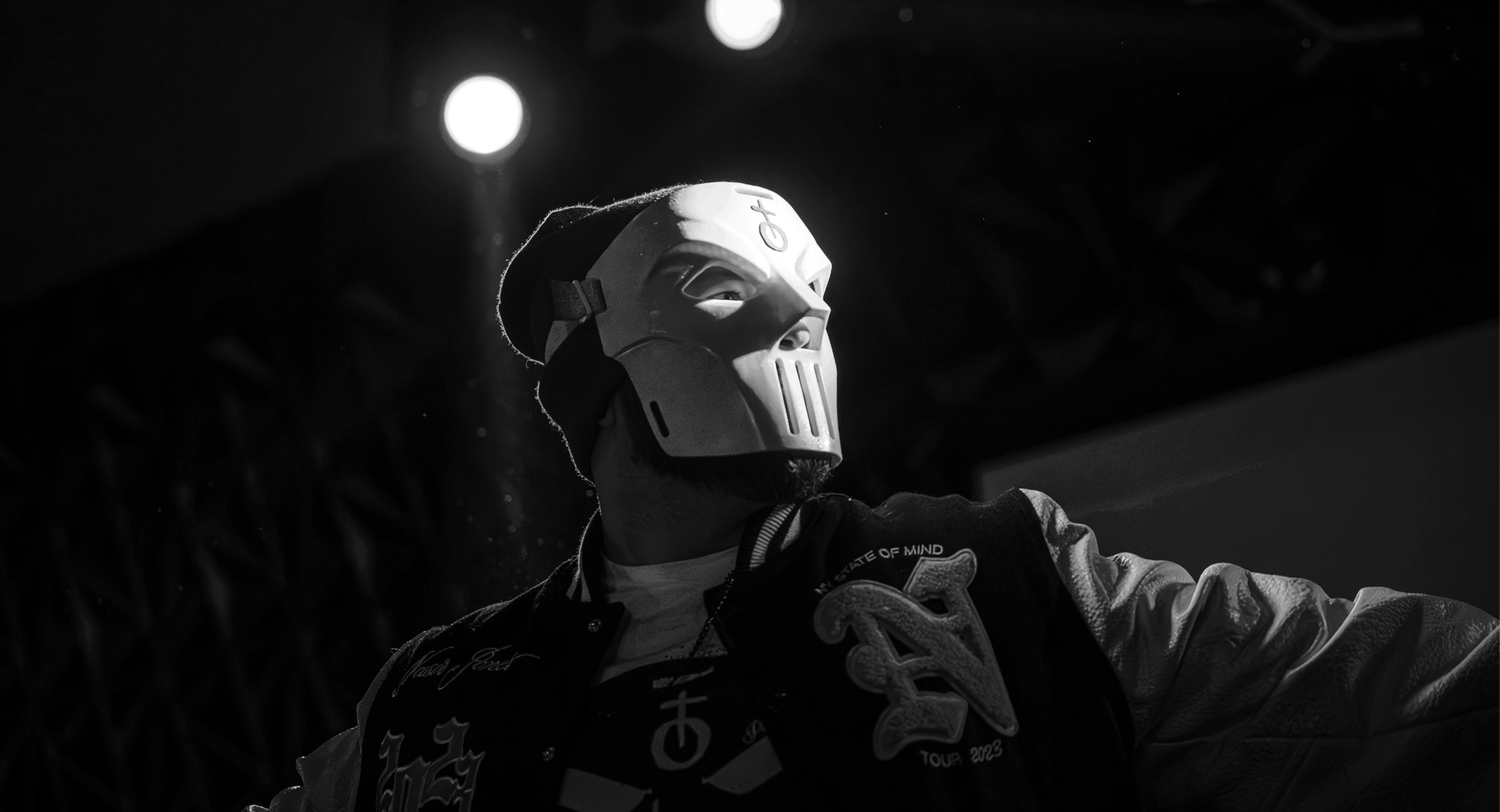 a black and white photo of a man wearing a mask