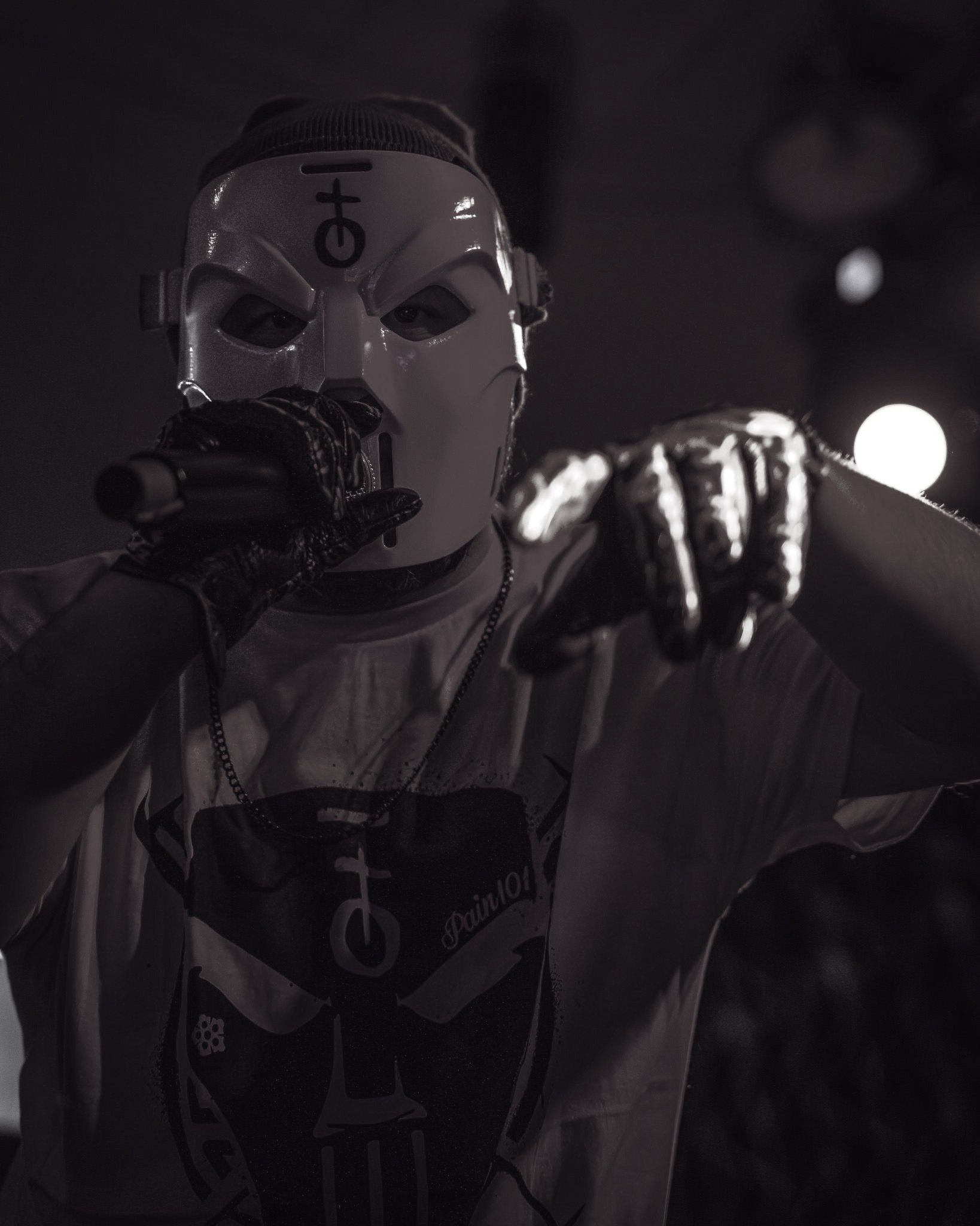 a man in a mask holding a microphone
