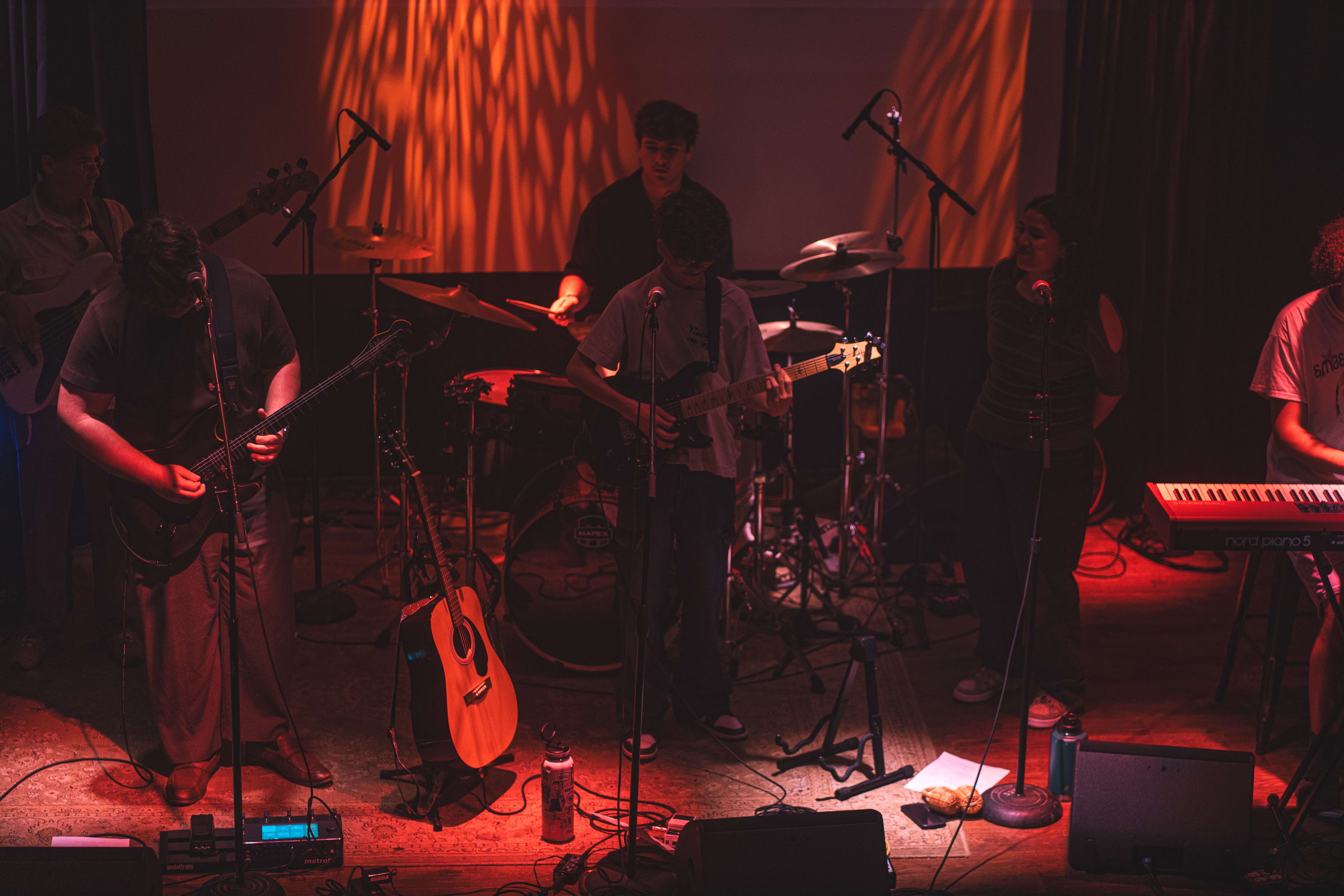 a group of people playing music on stage