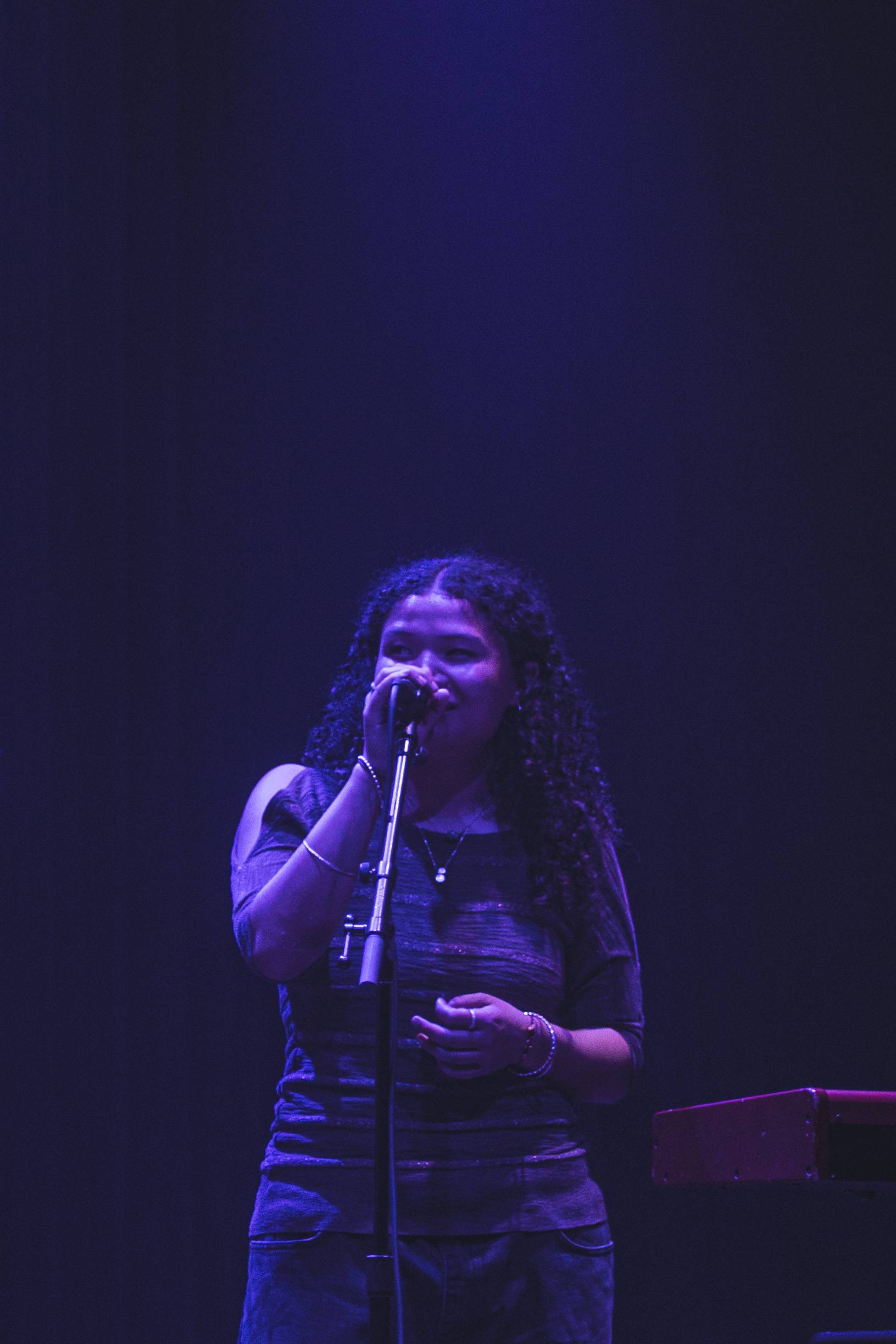 a woman singing into a microphone
