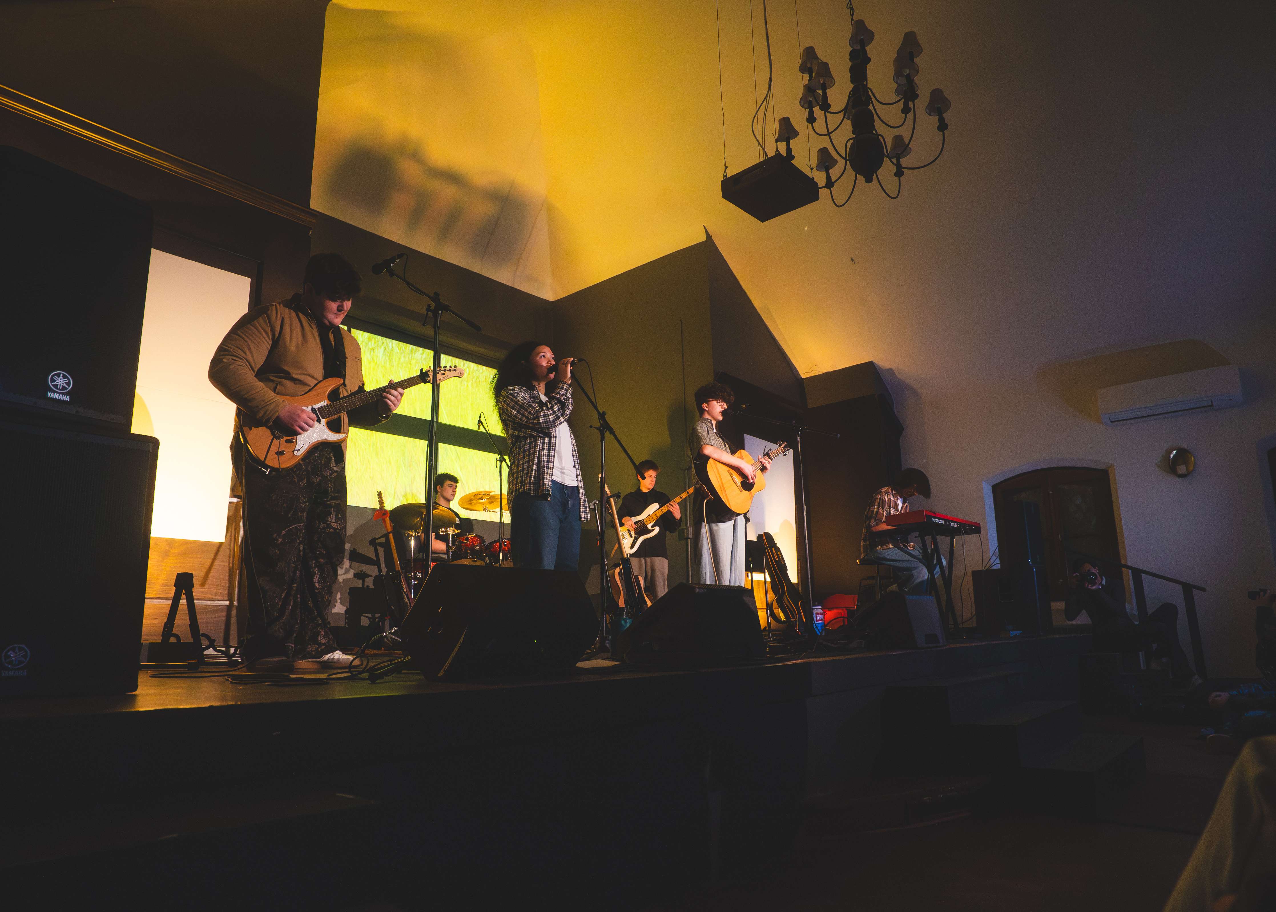 a group of people playing music in a room
