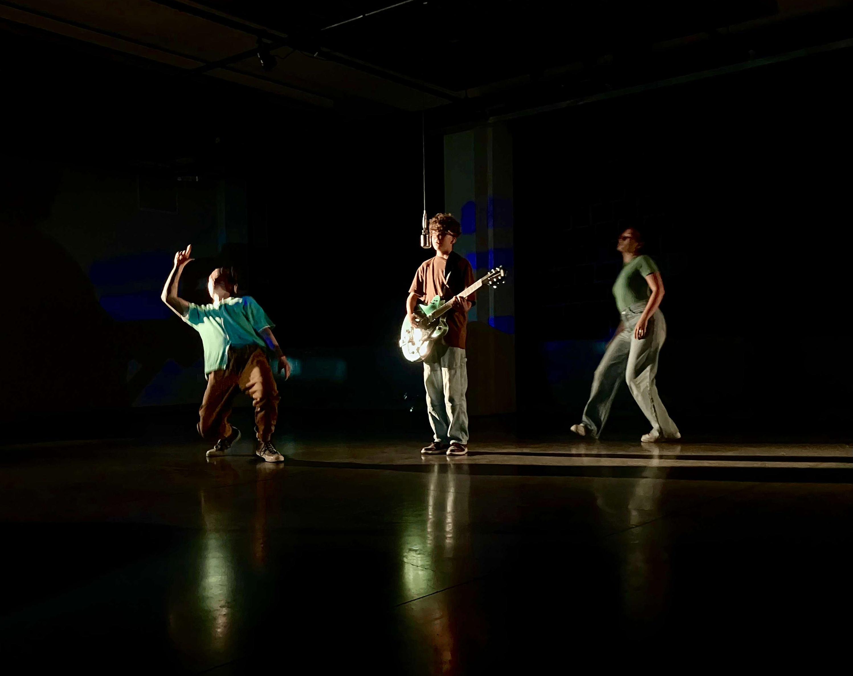 a group of people dancing in a dark room