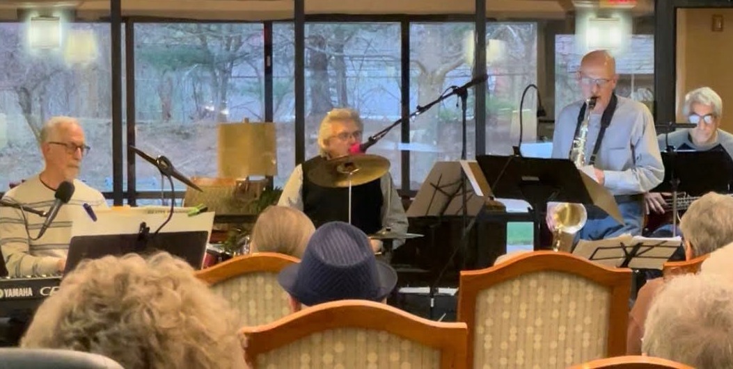 a group of people playing music in a room